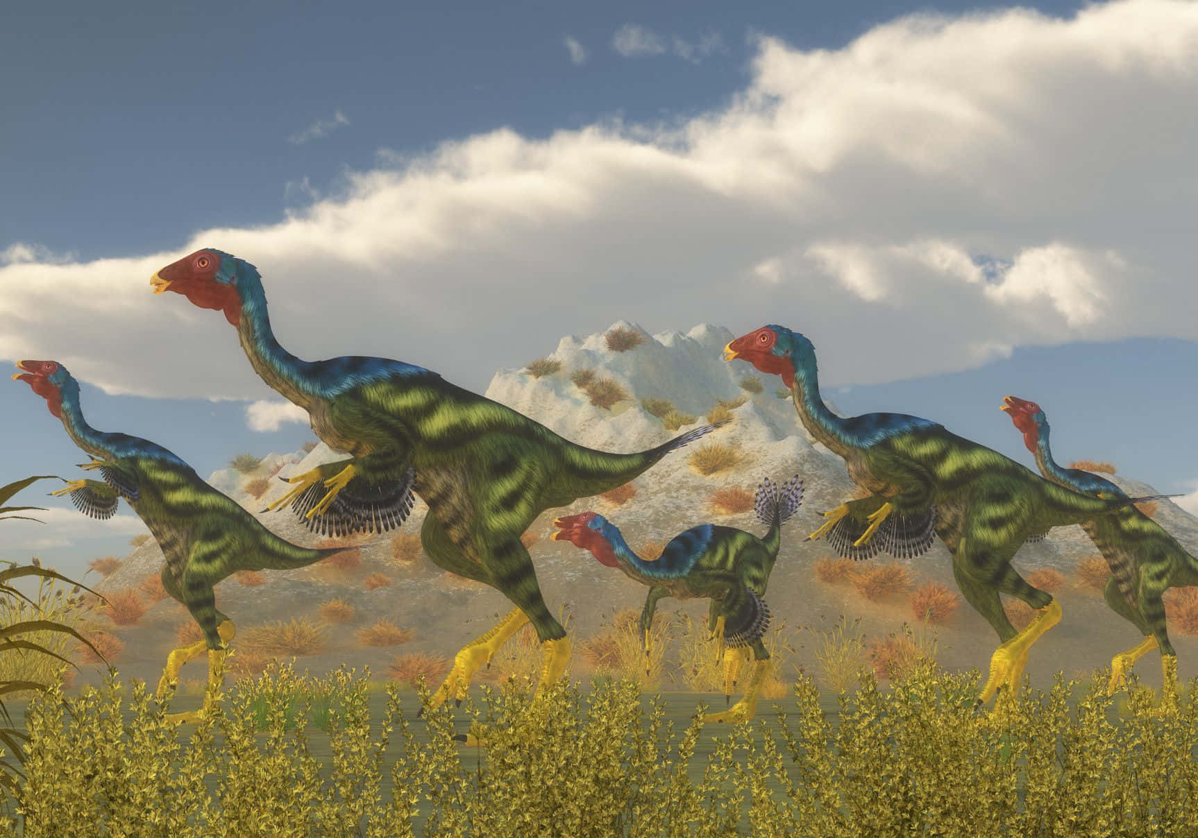 Dino 桌布 壁紙 — 一群色彩繽紛、有羽毛的恐龍，紅頭黃腿，在部分多雲的藍天下穿過金色草地奔跑。