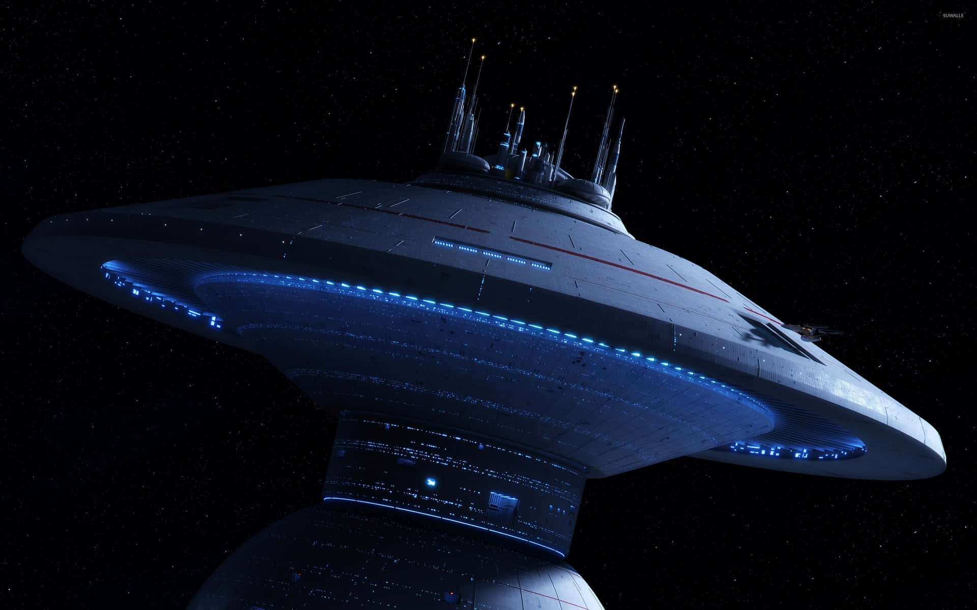 Starship 桌布 壁紙 — 一艘帶有發光藍光的未來太空船在繁星點點的黑色太空背景中盤旋。