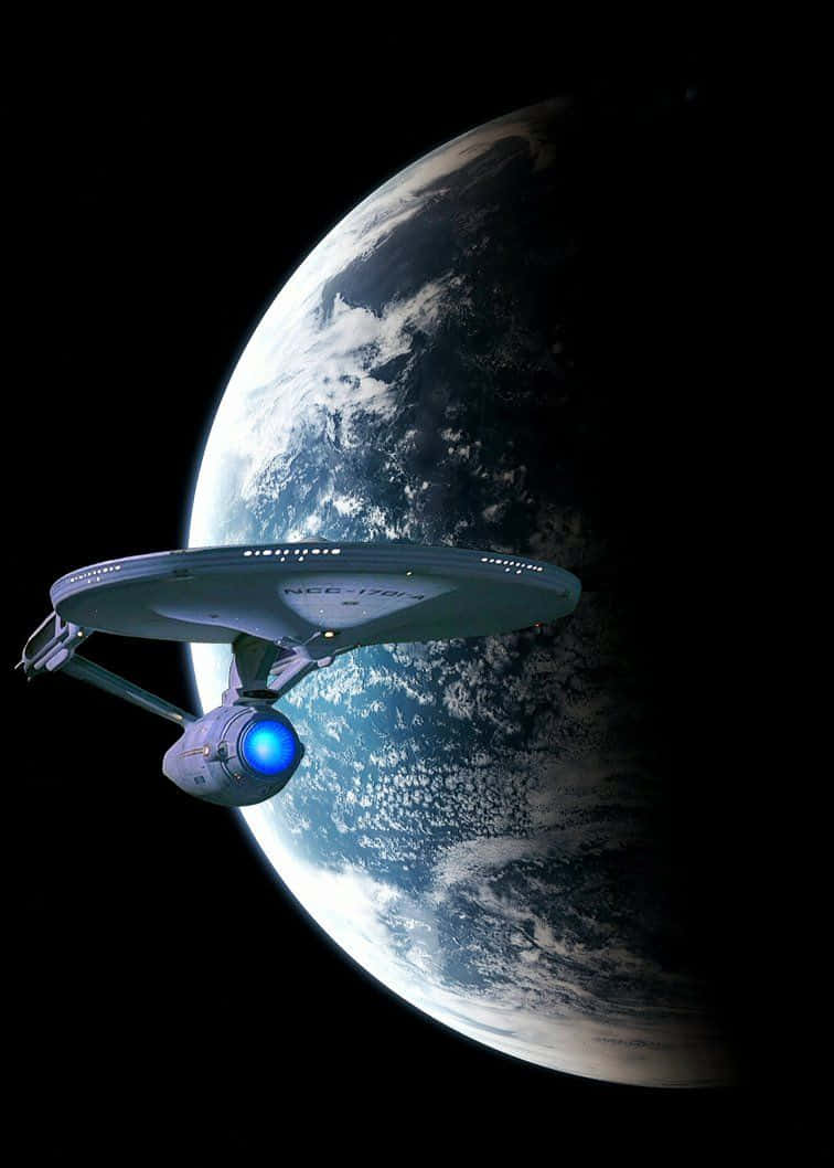 星艦在深空中環繞一顆藍色行星 — 星際爭霸戰 GIF 壁紙