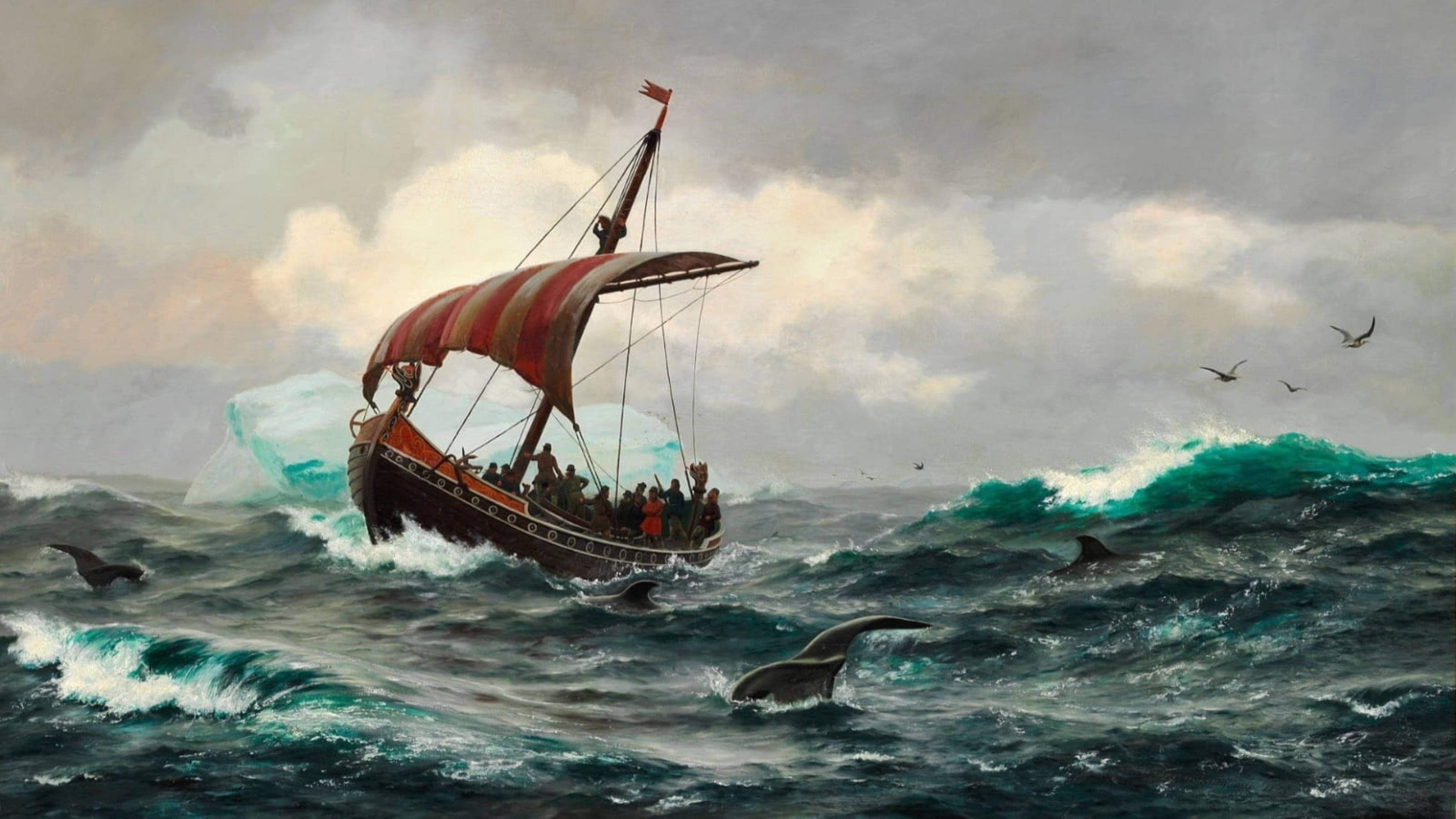 Viking Ship 桌布 壁紙 — 一艘木製帆船，帶有紅色條紋帆，在風暴天空下，在冰山和躍起的鯨魚之間與洶湧的綠色波浪搏鬥。
