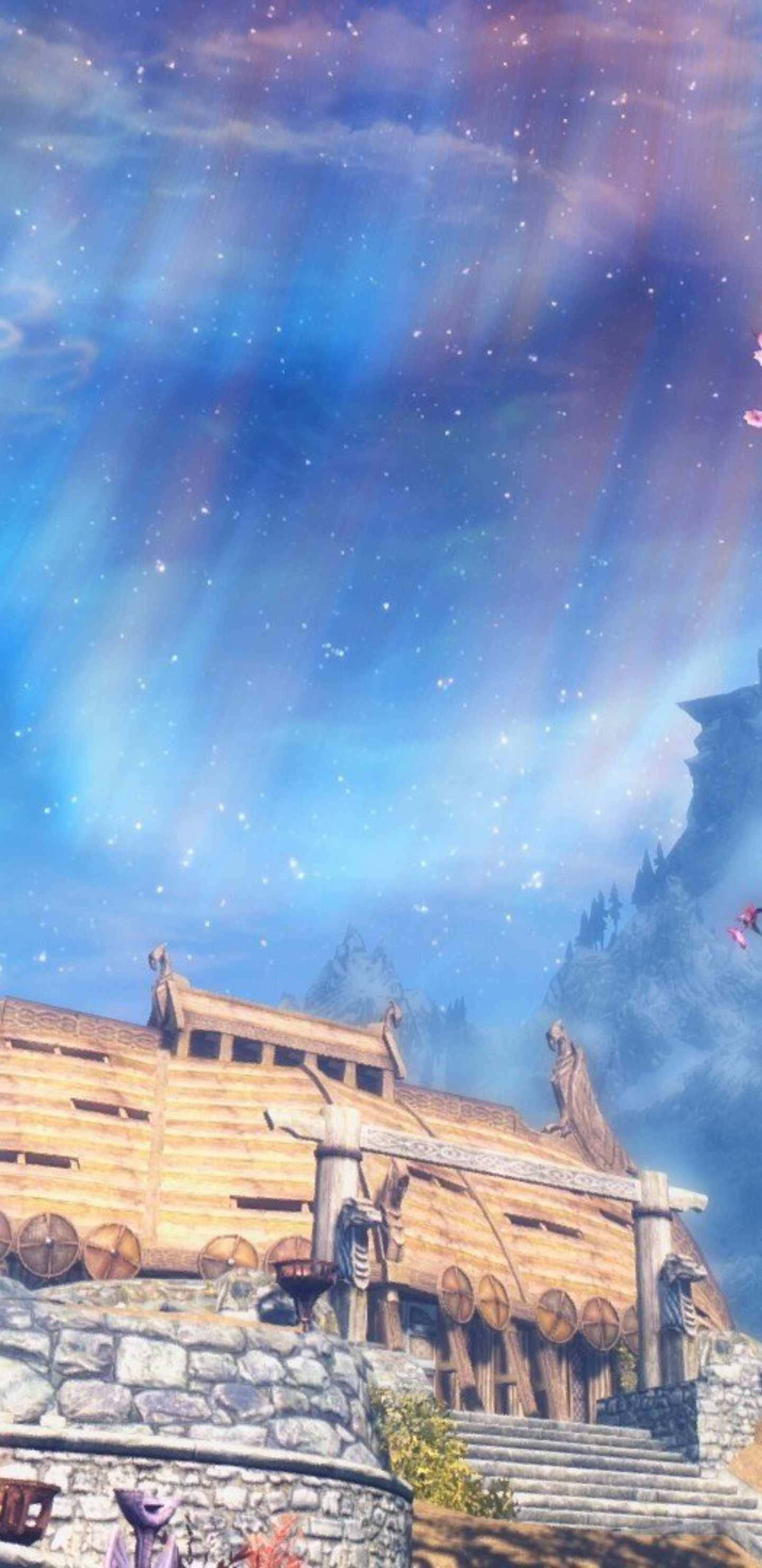 電玩遊戲 桌布 壁紙 — 一艘木製維京長船停放在石頭地基上，上方是充滿活力的極光天空，遠處有山脈。
