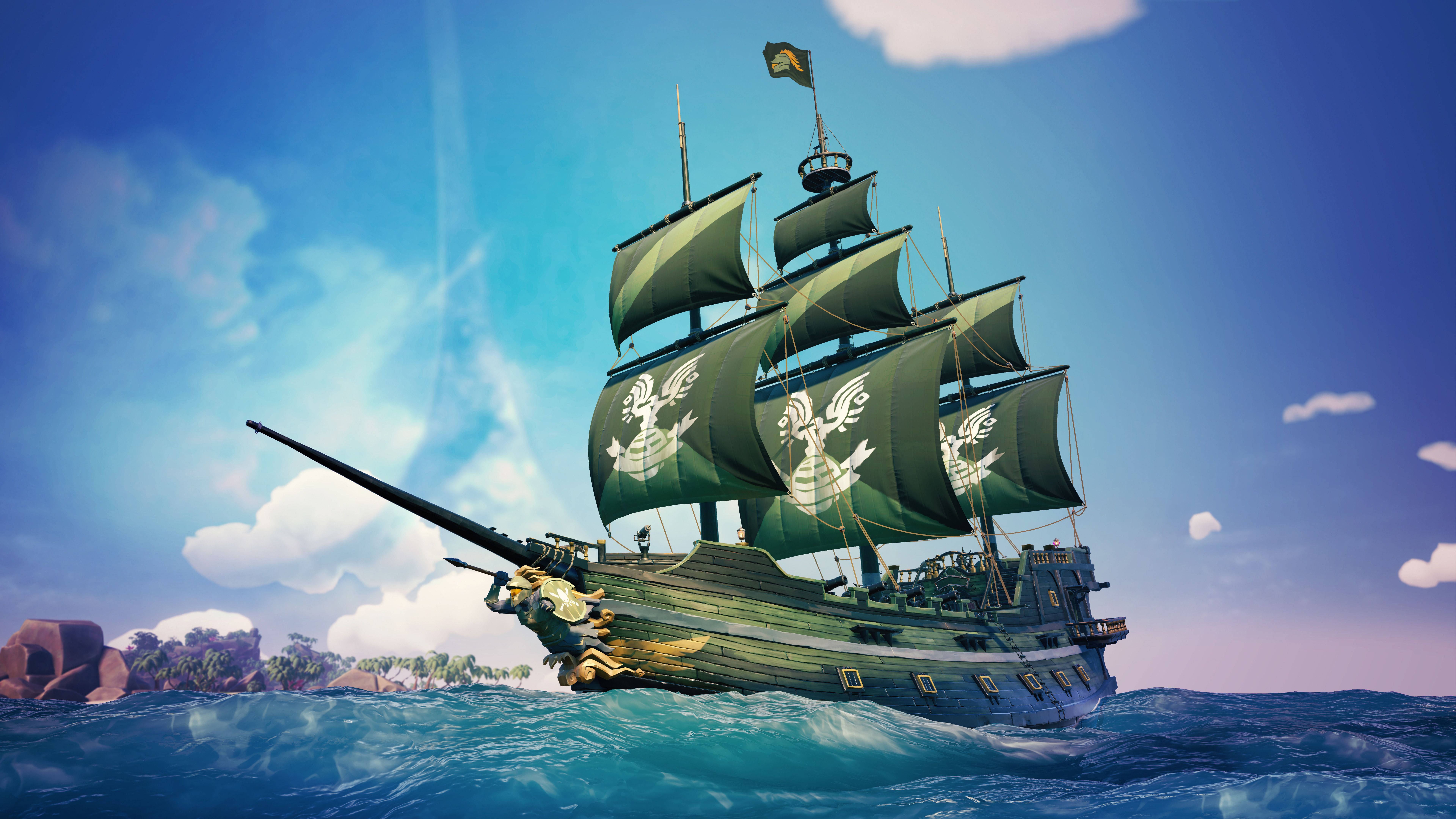 Sea Of Thieves 桌布 壁紙 — 一艘雄偉的綠色海盜船，帶有白色骷髏帆，在蔚藍的天空和蓬鬆的雲朵下，航行於碧綠色的波浪中。