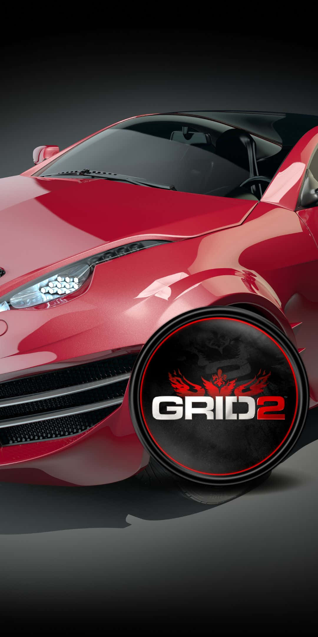 跑車 桌布 壁紙 — 一輛亮面紅色跑車，輪子上有「GRID 2」標誌，背景為深色攝影棚。