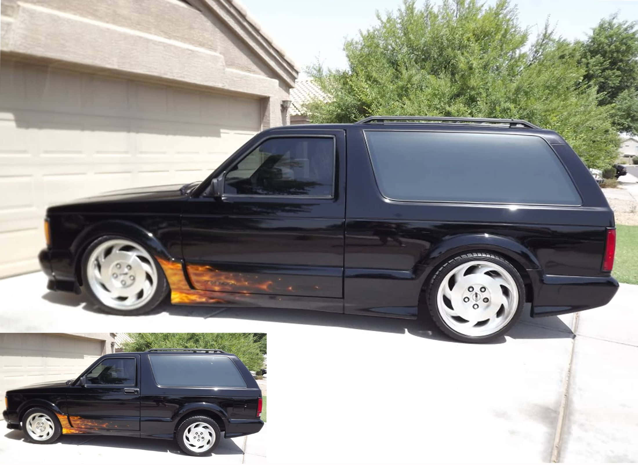Gmc Typhoon 桌布 壁紙 — 一輛亮黑色定制旅行車，帶有火橙色火焰貼紙，停在郊區住宅前。