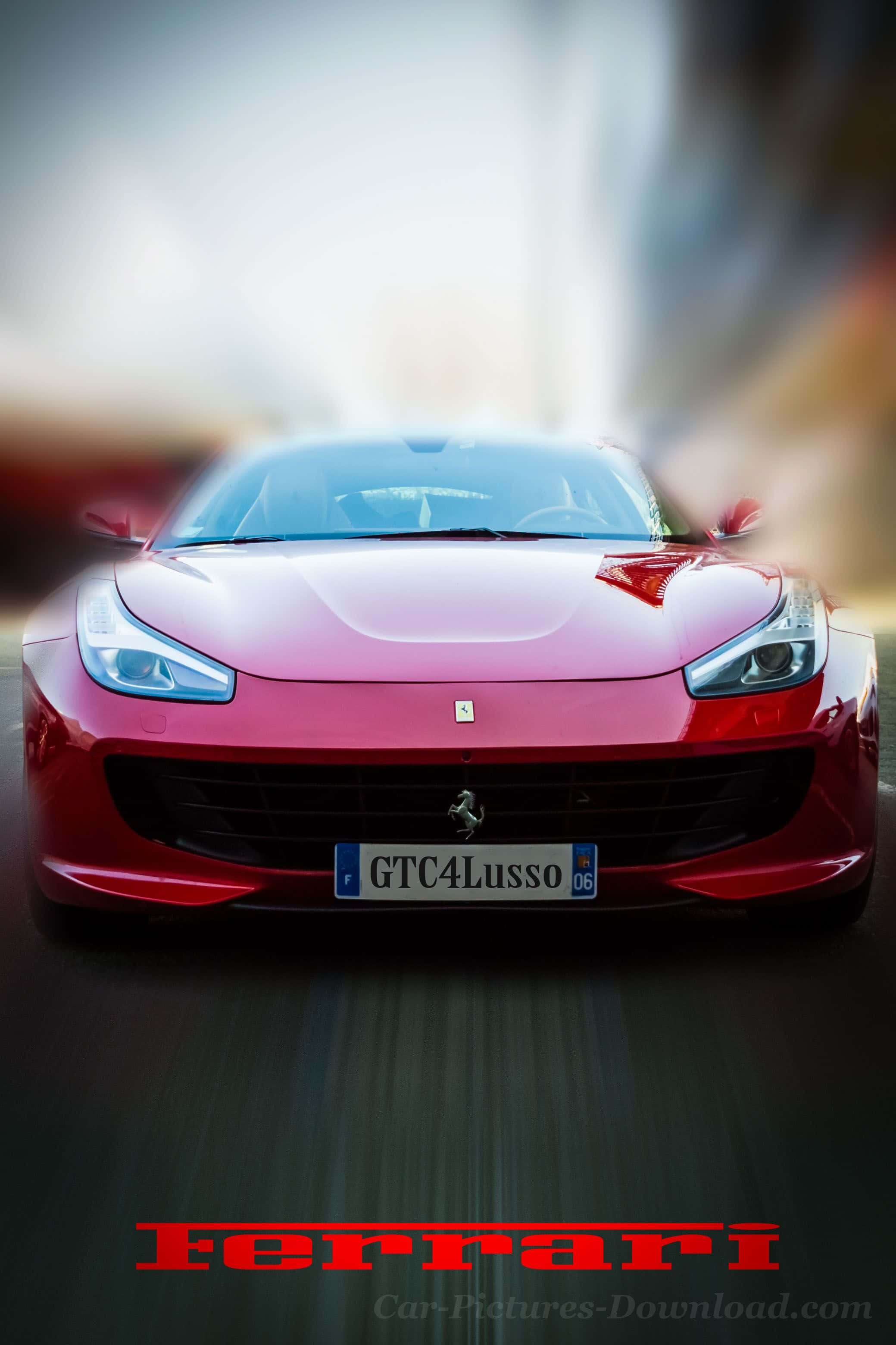 桌布 壁紙 — 一輛充滿活力的紅色法拉利 GTC4Lusso 向前飛馳，背景帶有動態模糊效果。