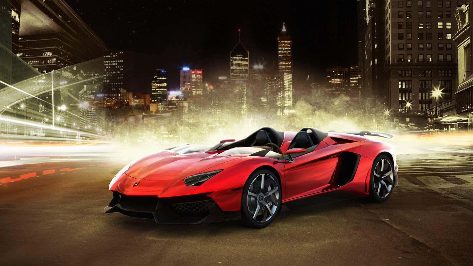 1920 X 1080 Car 桌布 壁紙 — 一輛充滿活力的紅色藍寶堅尼跑車在夜晚穿過霓虹燈閃爍的城市景觀，帶有動態模糊痕跡。