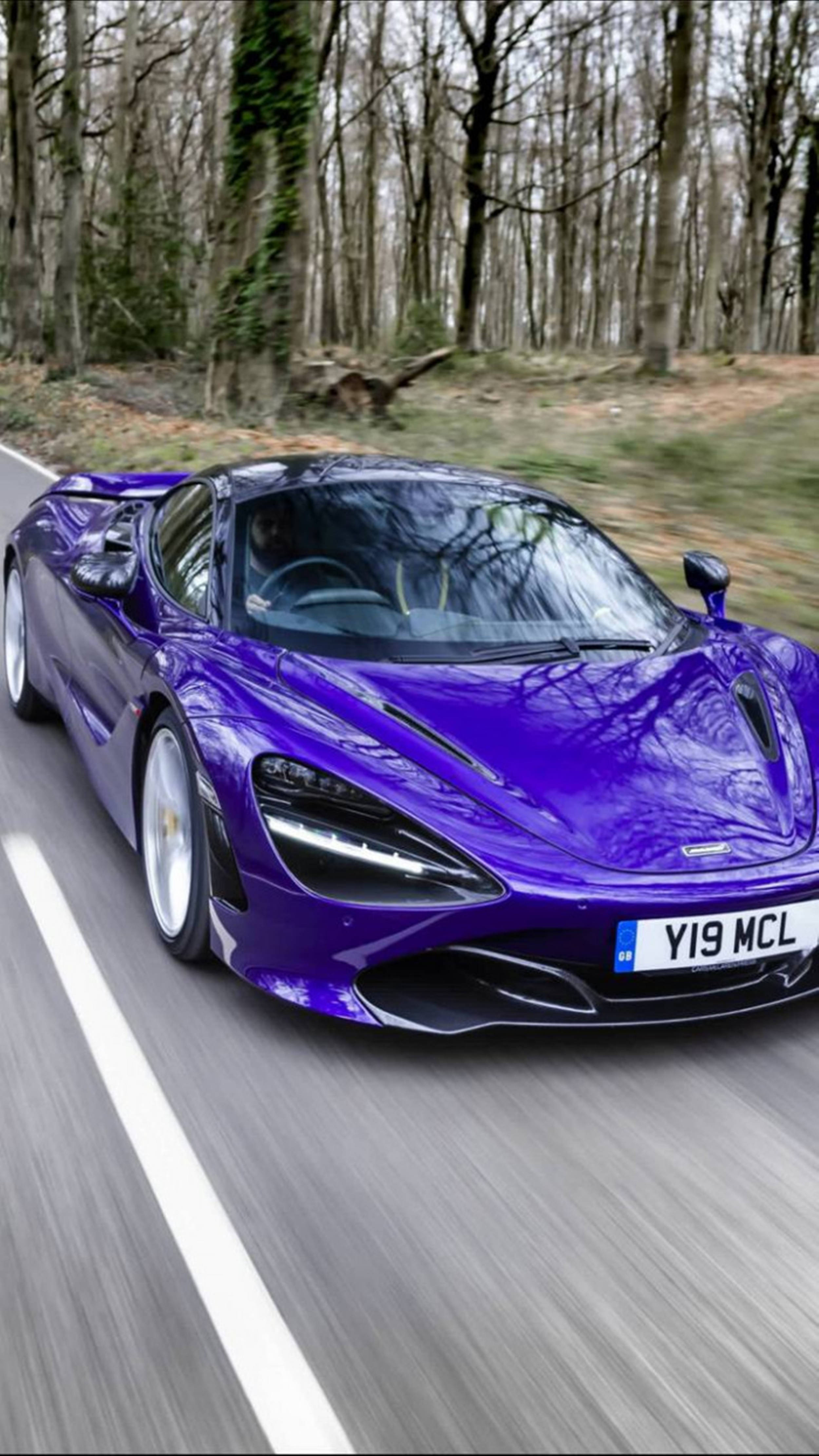 Luxury 桌布 壁紙 — 一輛充滿活力的紫色McLaren跑車在森林道路上疾馳，周圍帶有動態模糊效果。