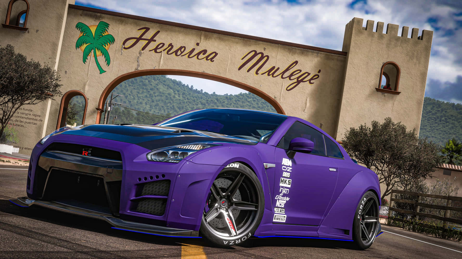 Purple Nissan GTR in Mexico 壁紙 — 一輛充滿活力的紫色日產GT-R，帶有黑色飾邊和贊助商貼紙，停靠在英雄穆萊赫拱門下，背景是山脈。