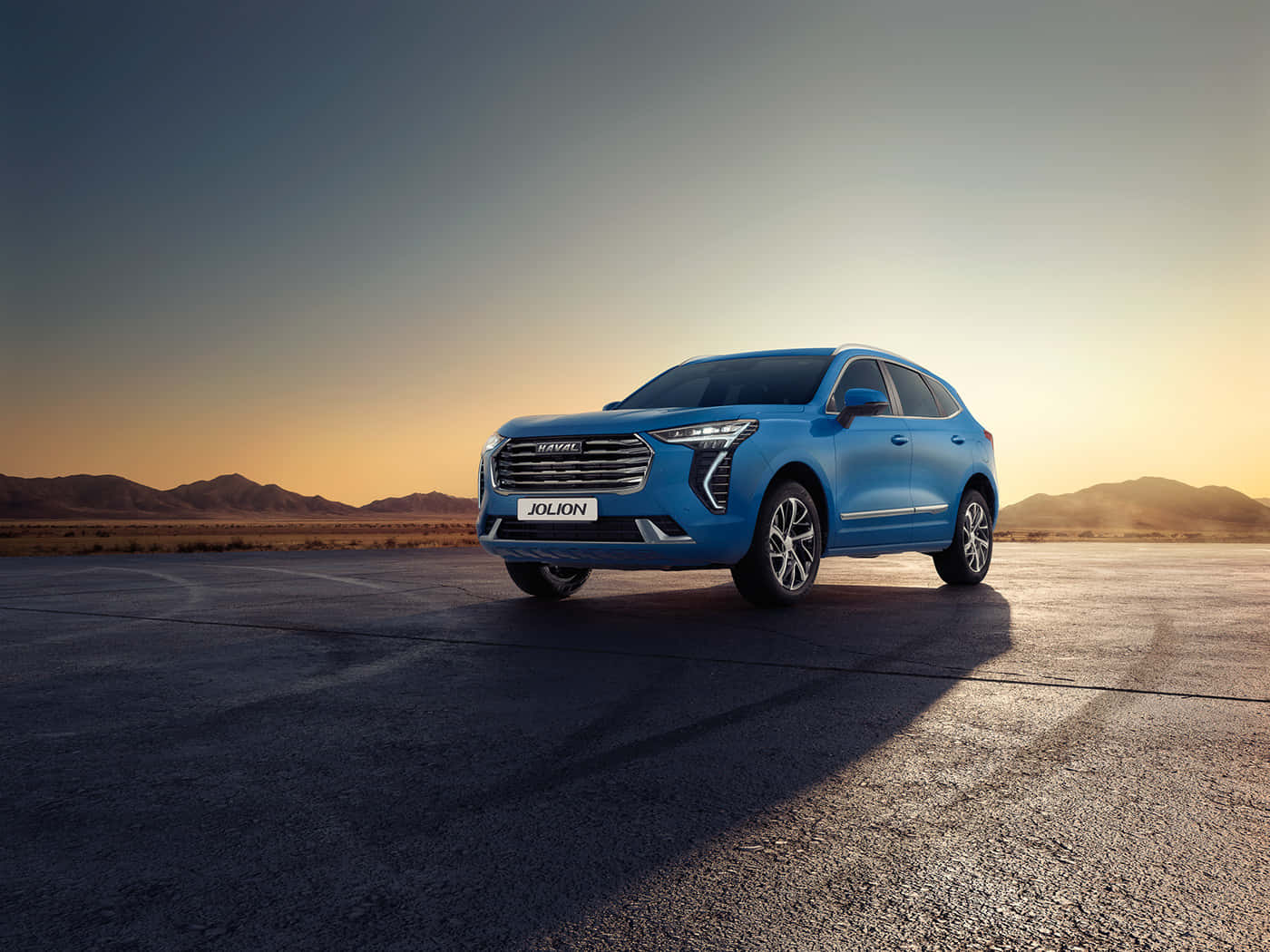 Haval 桌布 壁紙 — 一輛充滿活力的藍色Jolion SUV在金色日落時分停在沙漠跑道上，遠山在溫暖漸變的天空中形成剪影。