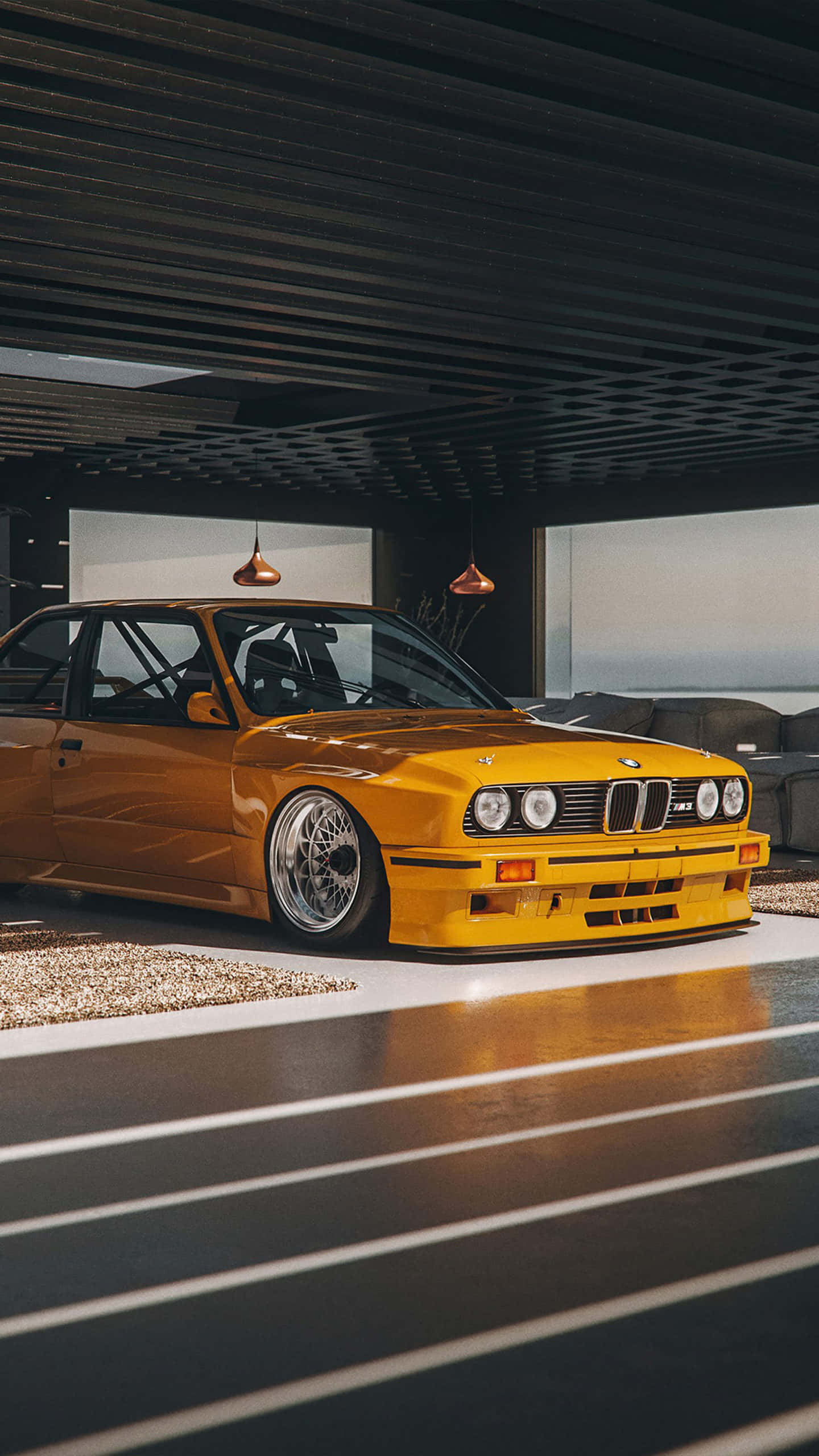 BMW 動圖 桌布 壁紙 — 一輛充滿活力的黃色BMW E30賽車優雅地停放在現代簡約風格的車庫中，配有時尚的照明和拋光地板。
