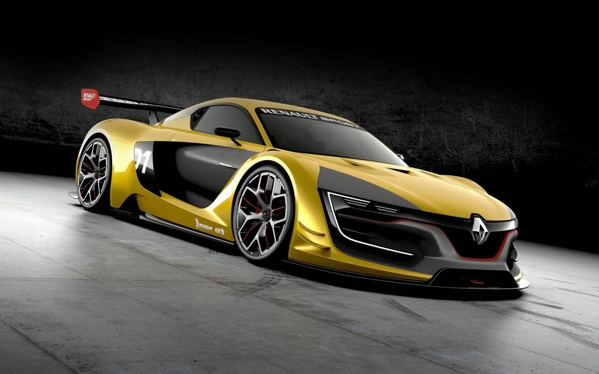 Renault 桌布 壁紙 — 一輛光滑的金色雷諾賽車，帶有黑色裝飾和77號，停在混凝土地板上，背景是深色紋理牆壁。