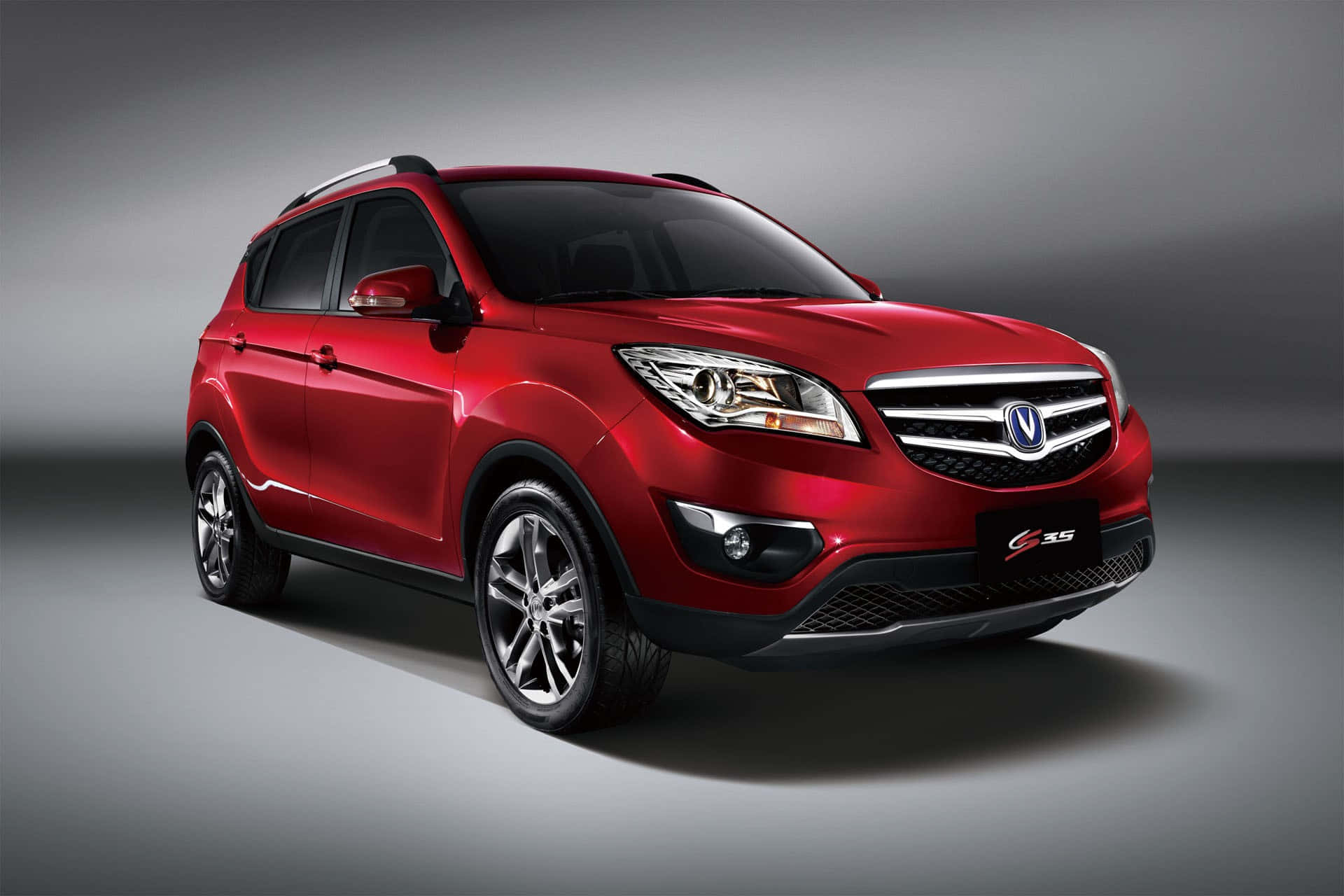 Changan 桌布 壁紙 — 一輛光澤紅色緊湊型SUV，帶有鍍鉻飾條和合金輪圈，在漸變灰色工作室背景前展示。