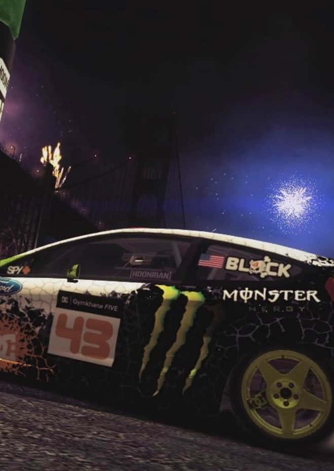 遊戲 桌布 壁紙 — 一輛帶有Monster Energy品牌的黑黃色漂移車在煙火和城市燈光下夜間比賽。