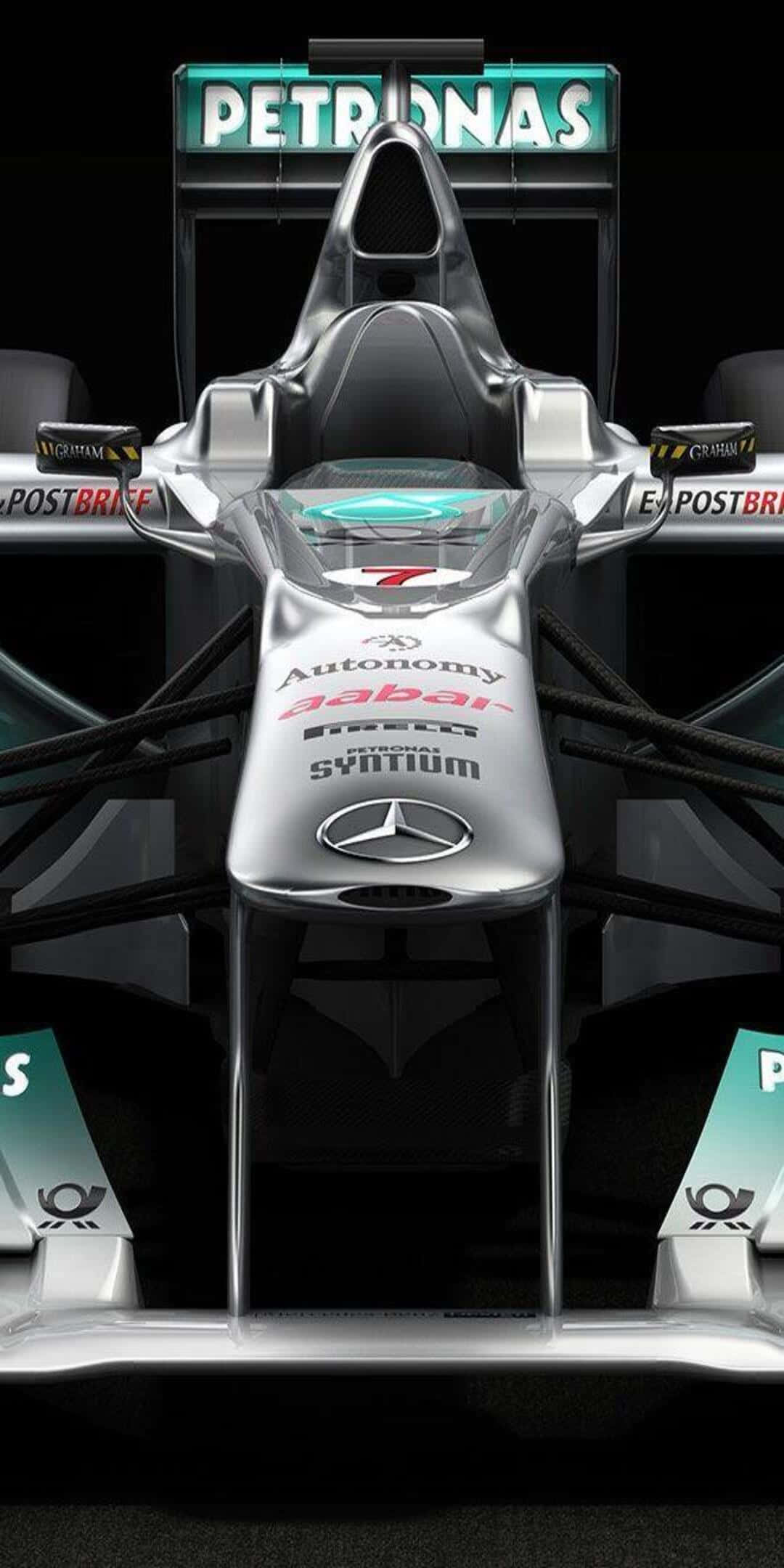F1 桌布 壁紙 — 一輛帶有Petronas品牌標誌的時尚銀色一級方程式賽車，從正面觀看，背景為黑色。