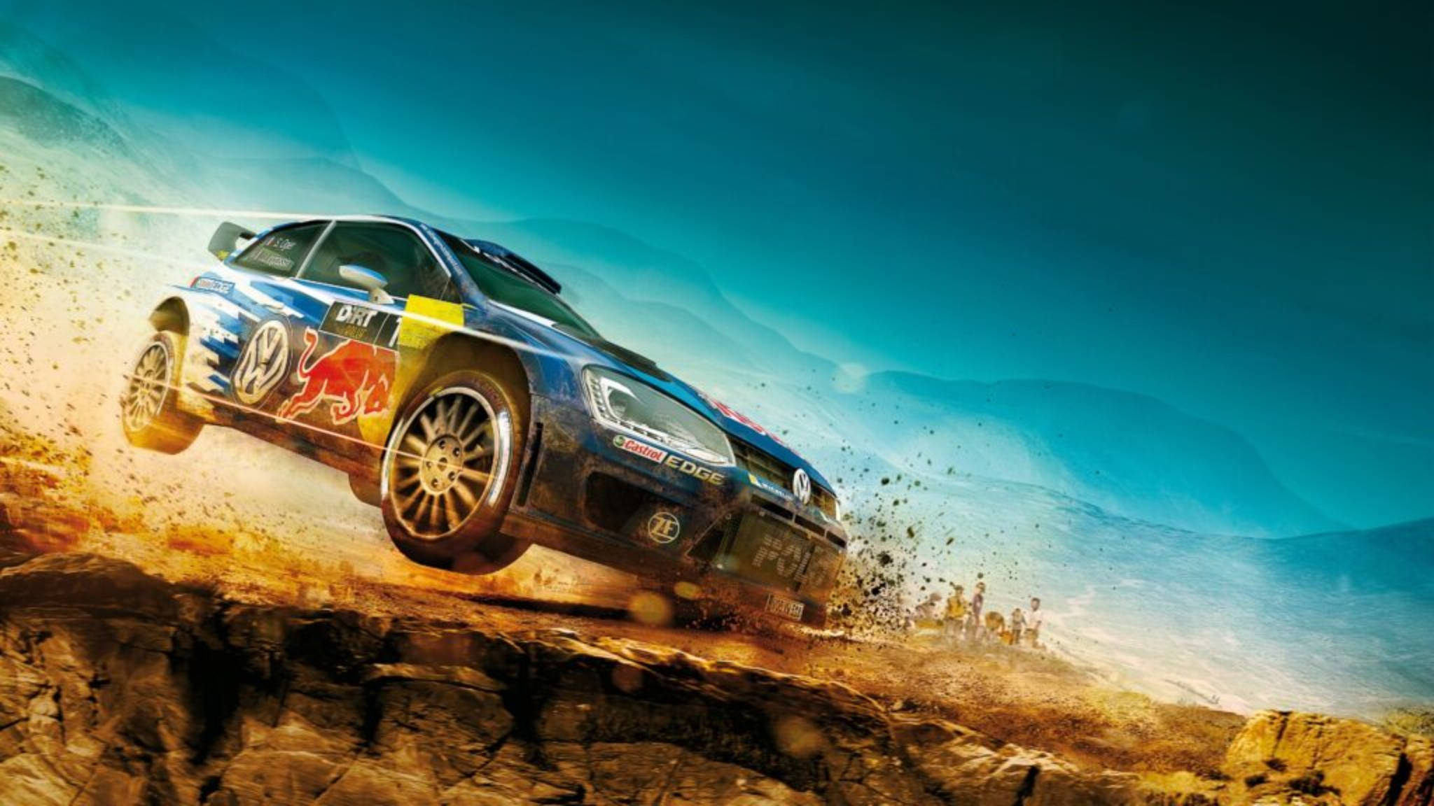 Dirt 3 桌布 壁紙 — 一輛帶有Red Bull塗裝的藍色拉力賽車在岩石沙漠懸崖上飛躍，在充滿活力的藍天下揚起灰塵。