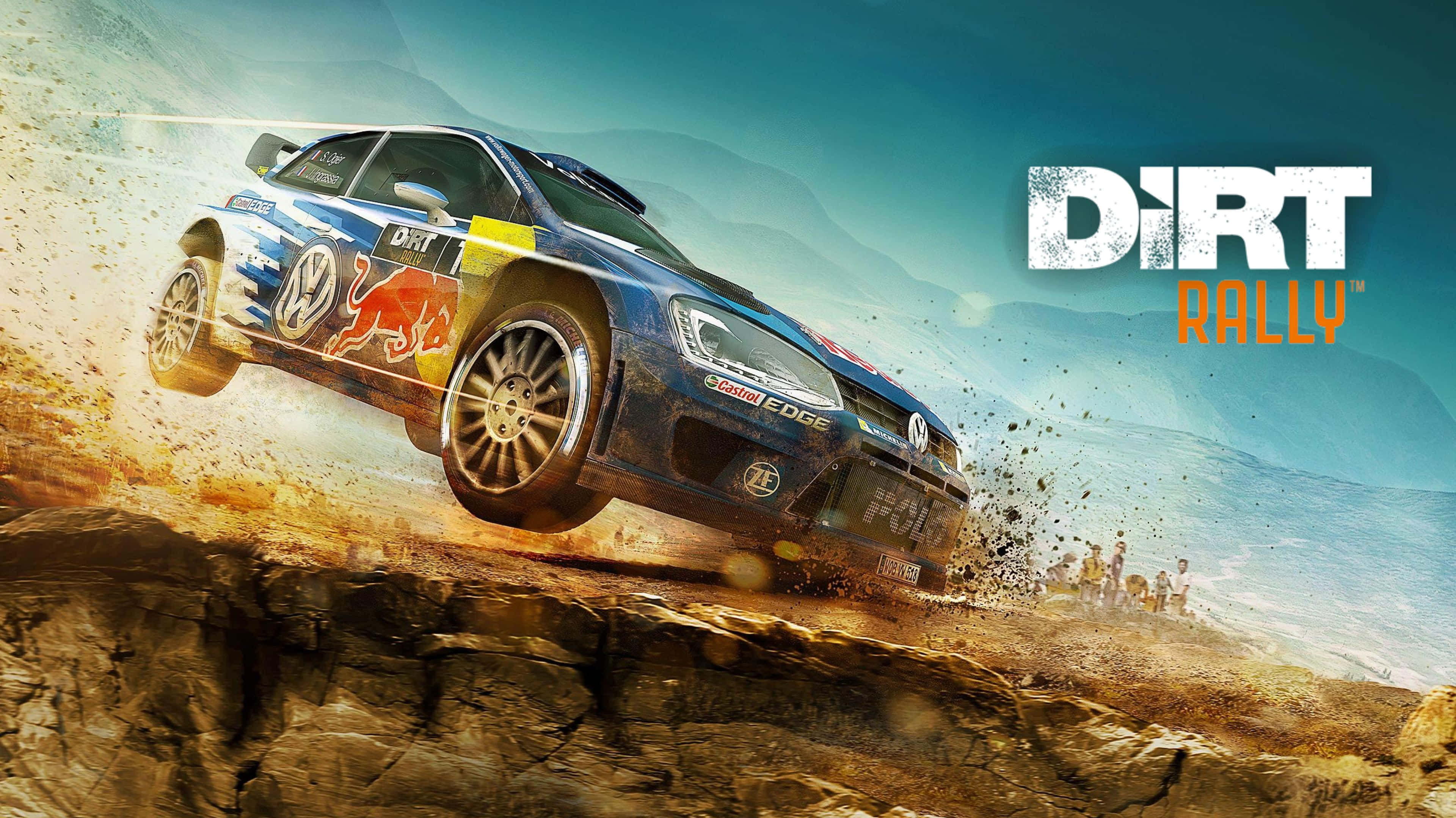 4K Dirt Rally 桌布 壁紙 — 一輛帶有Red Bull塗裝的藍色拉力賽車飛躍岩石峭壁，在山巒背景下揚起塵土。