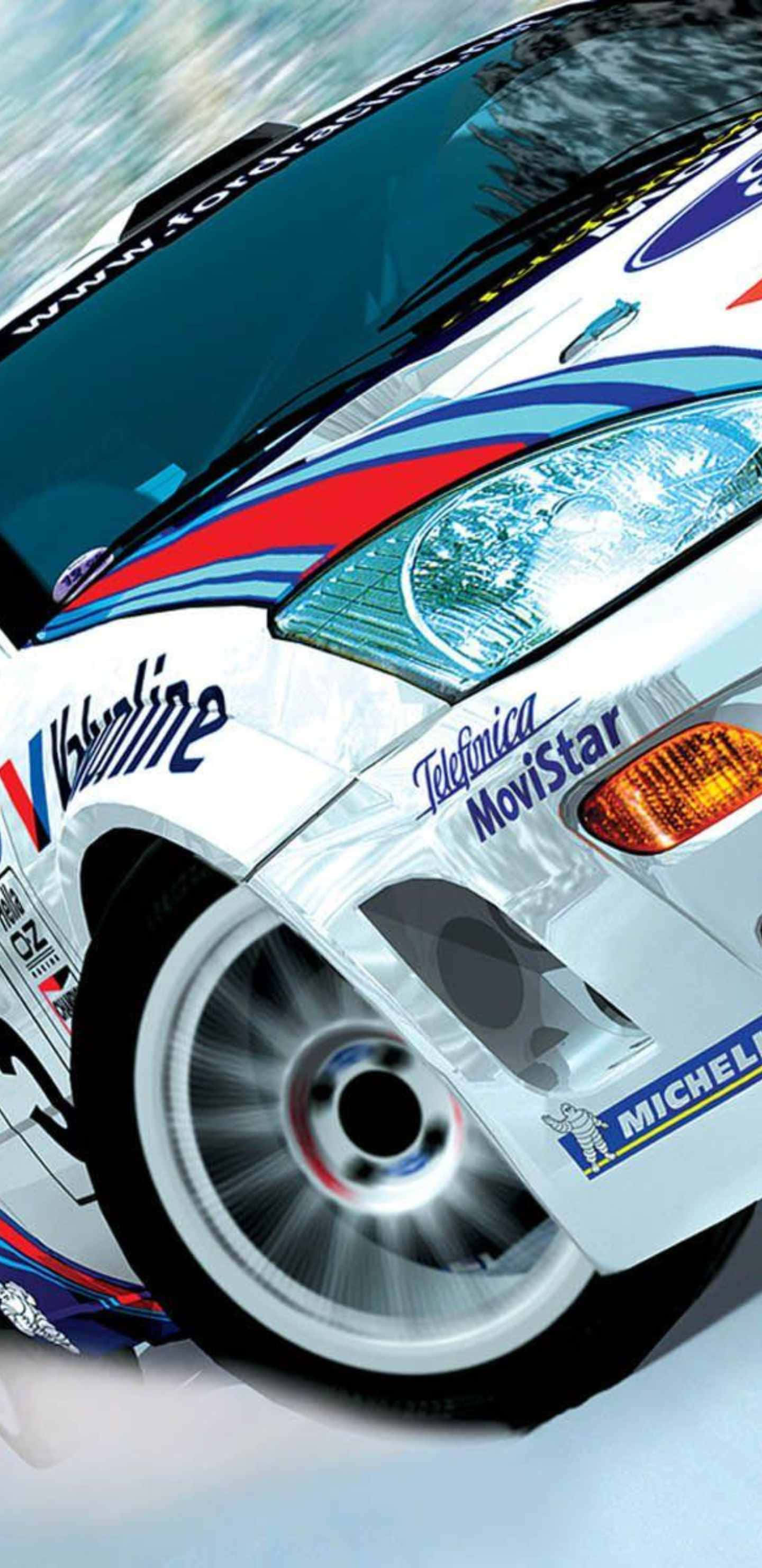 Android Dirt Rally 桌布 壁紙 — 一輛帶有Valvoline和Michelin品牌的高速拉力賽車在雪景中飛馳，車輪因運動而模糊。