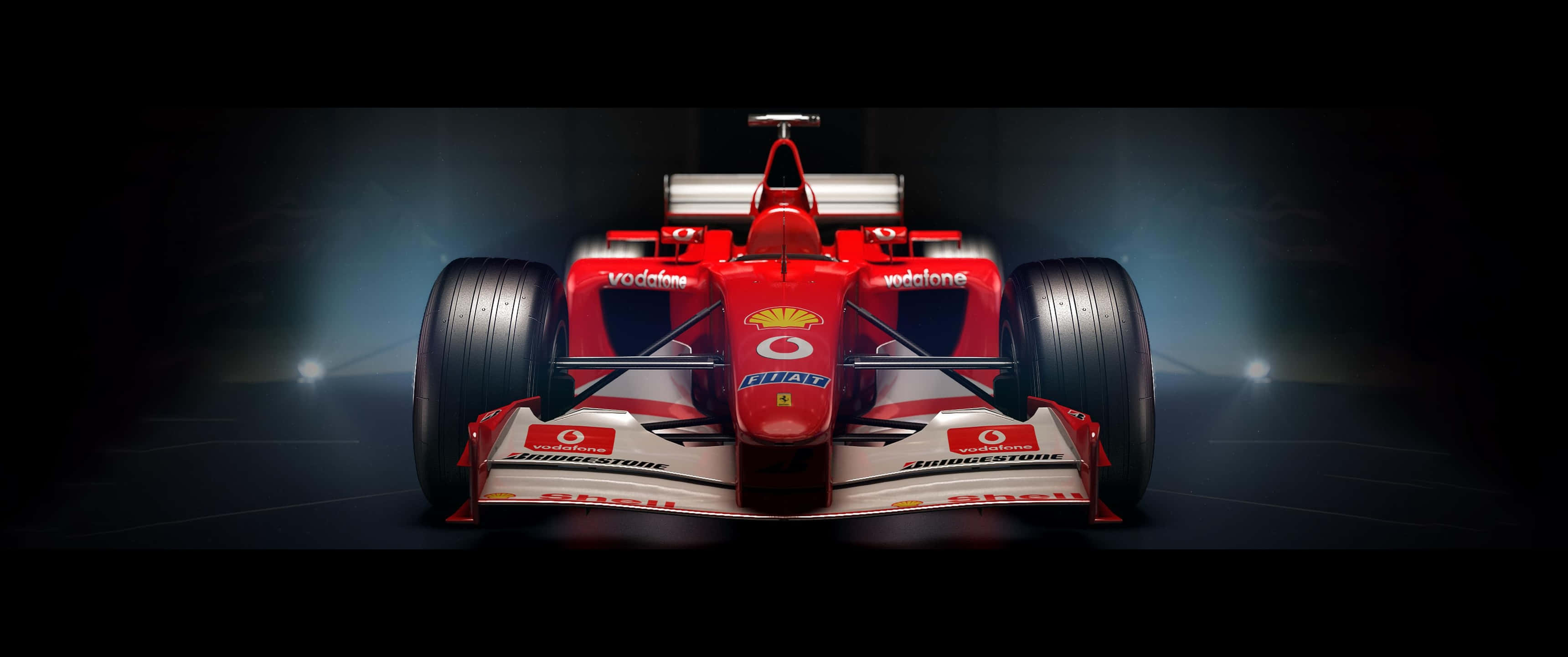 汽車 桌布 壁紙 — 一輛帶有Vodafone和Shell標誌的紅色法拉利F1賽車，在黑暗的舞台上被聚光燈從下方戲劇性地照亮。