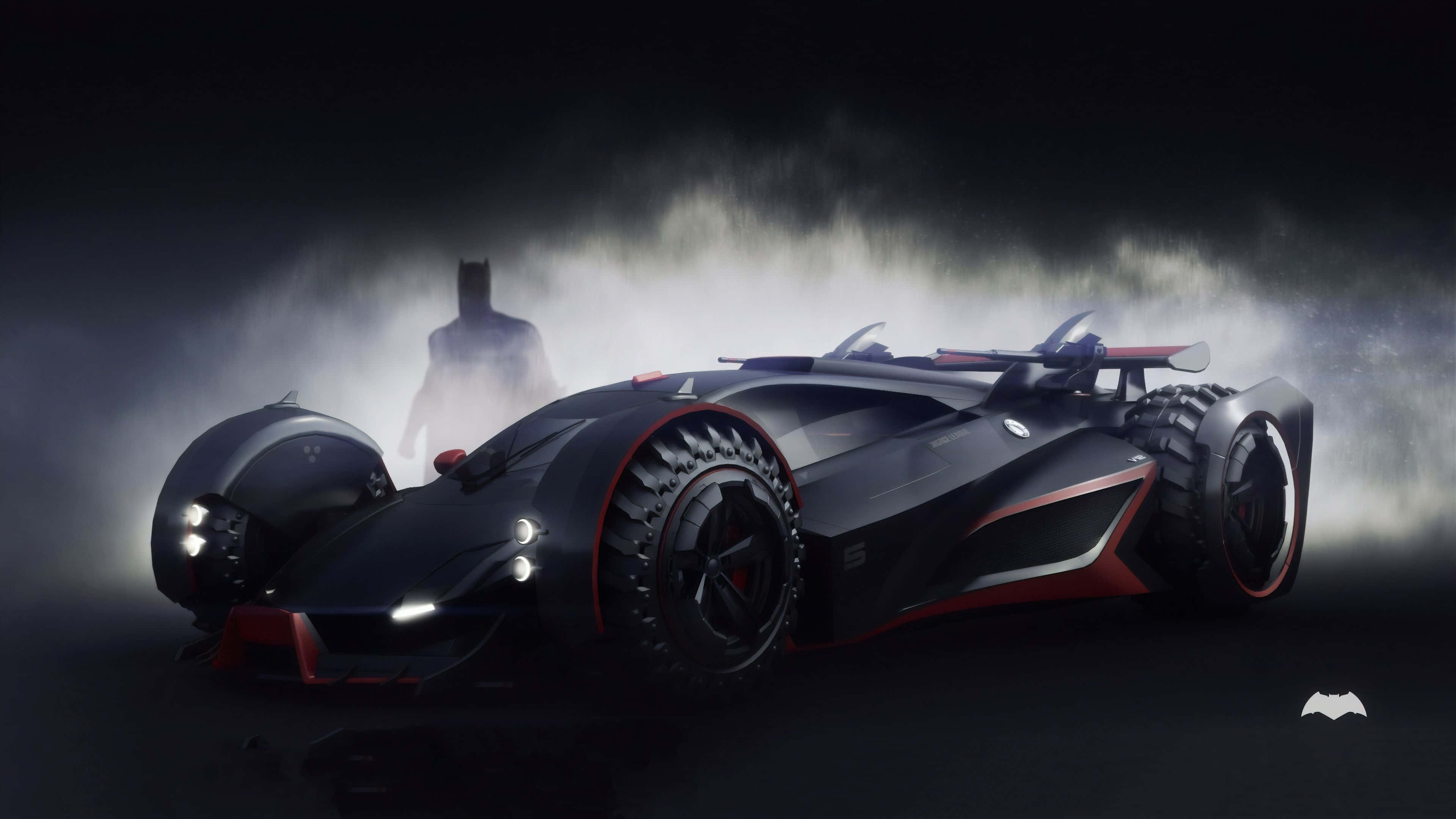 4K Batmobile 桌布 壁紙 — 一輛帶有紅色點綴和巨大輪胎的時尚黑色蝙蝠車從迷霧中出現，蝙蝠俠的剪影在後方若隱若現。