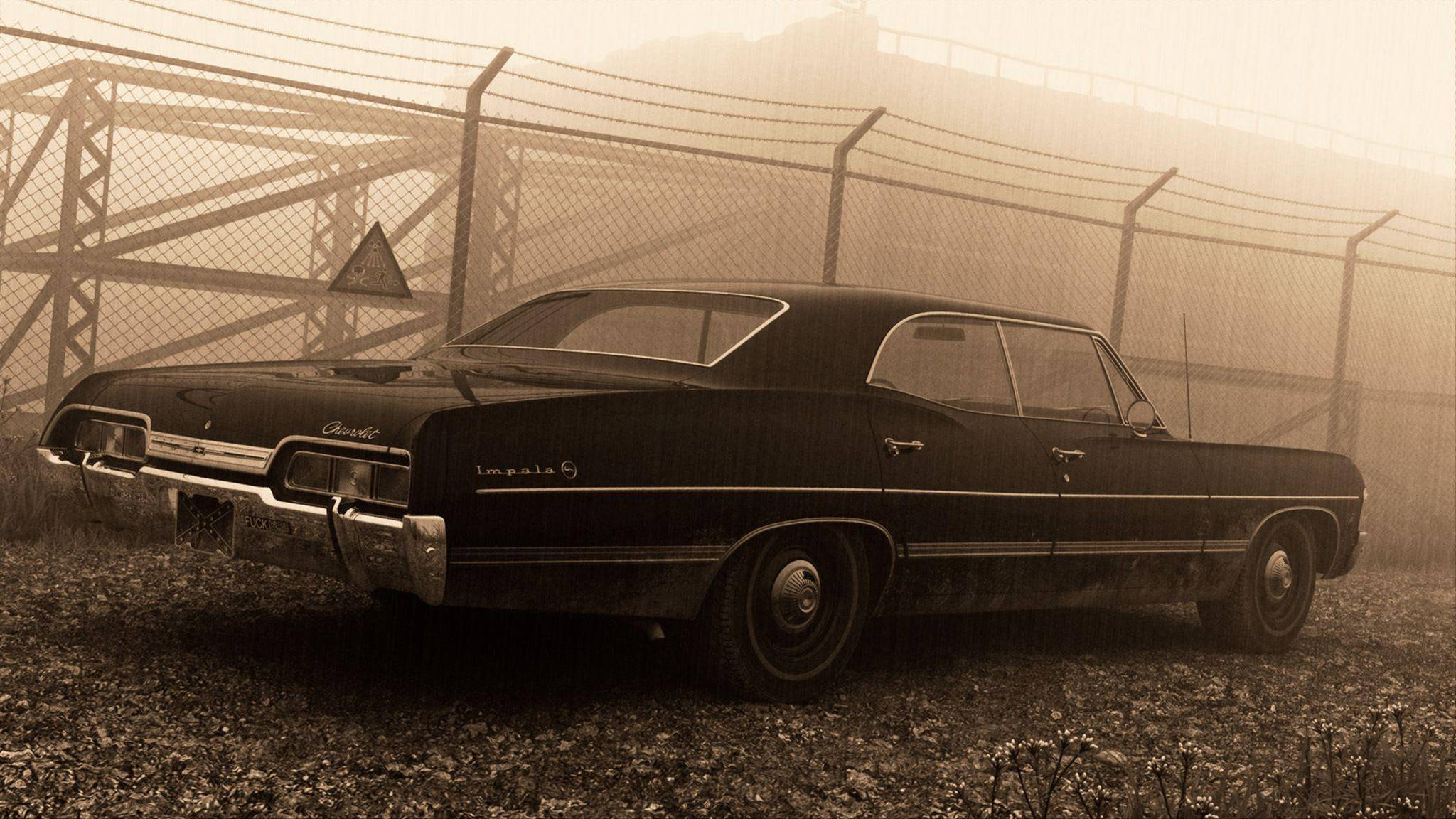 chevrolet impala 1967 桌布 壁紙 — 一輛復古黑色雪佛蘭Impala被遺棄在碎石上，後面有鐵絲網圍欄，場景朦朧，呈現懷舊的棕褐色調。