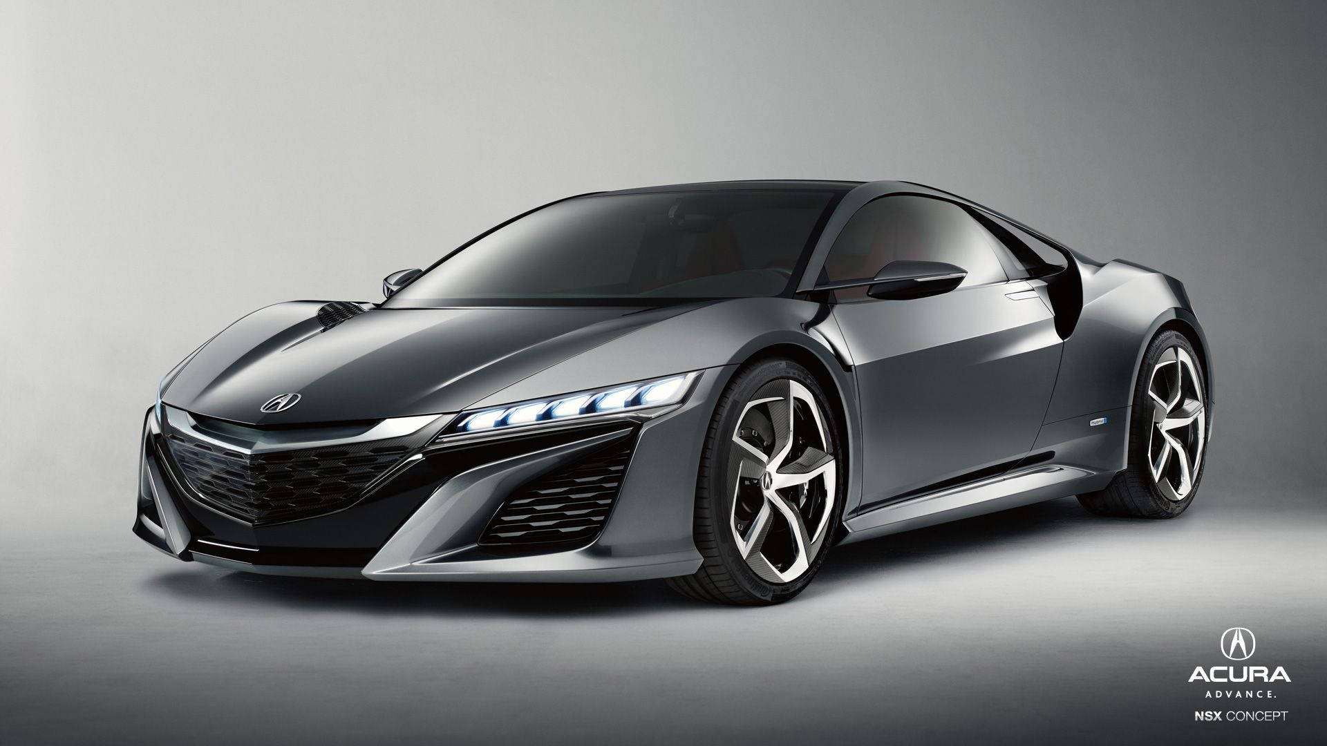 汽車 桌布 壁紙 — 一輛時尚未來感的Acura NSX概念車在攝影棚燈光下閃耀金屬灰色，展示銳利的空氣動力學線條和發光的LED頭燈。