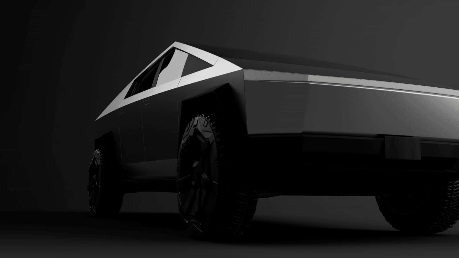 Cybertruck 桌布 壁紙 — 一輛時尚棱角分明的黑色Tesla Cybertruck在戲劇性的攝影棚燈光下，以深灰色背景為襯。