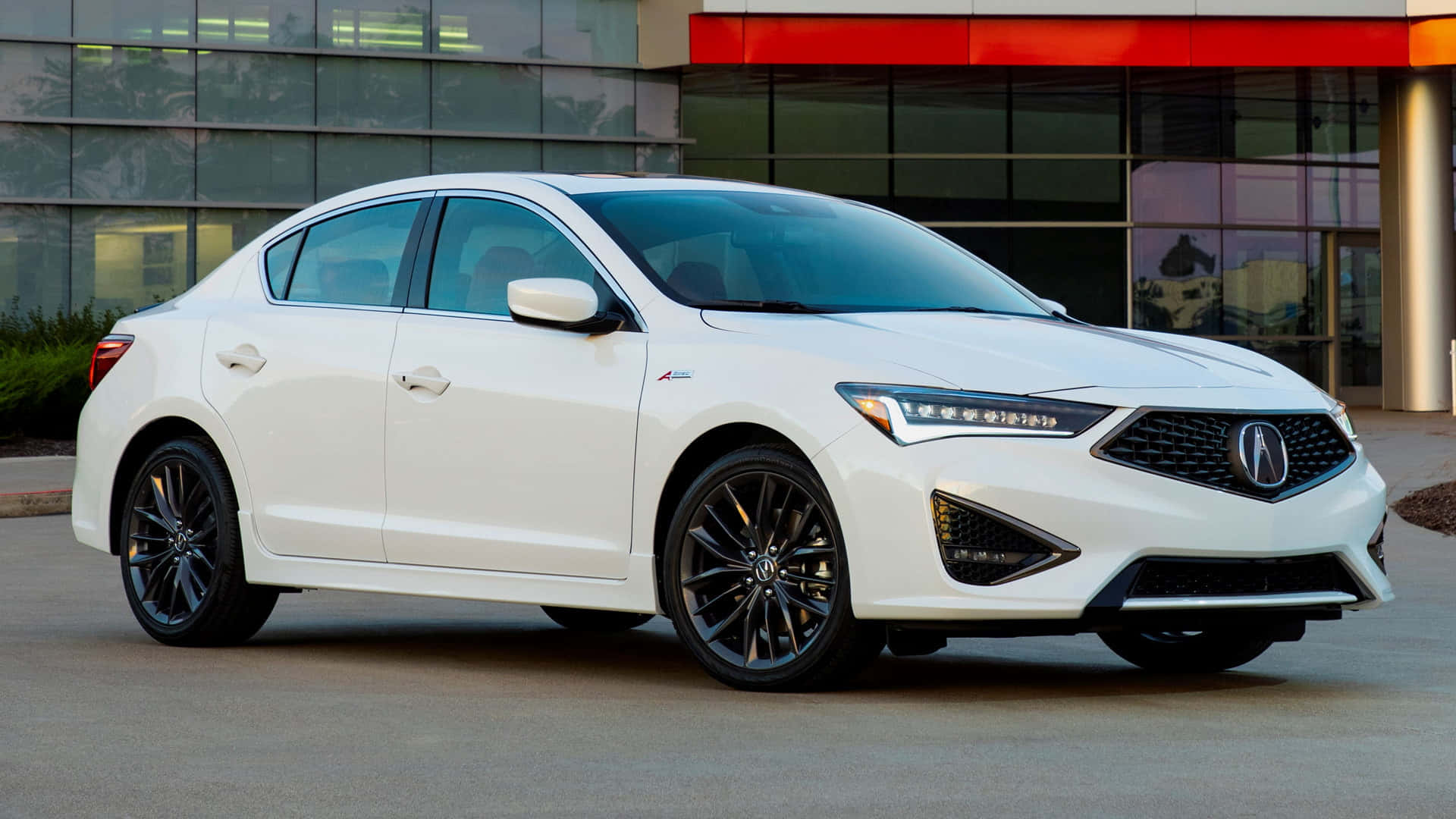Acura Ilx 桌布 壁紙 — 一輛時尚的白色Acura轎車搭配黑色輪圈，停放在現代玻璃建築前。