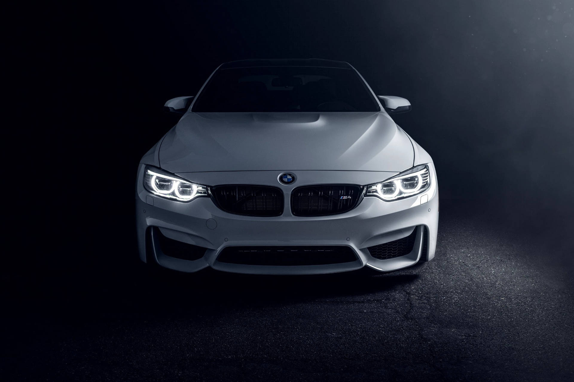 在黑暗攝影棚環境中，白色BMW跑車車頭燈閃爍。 — 4K筆電壁紙 壁紙