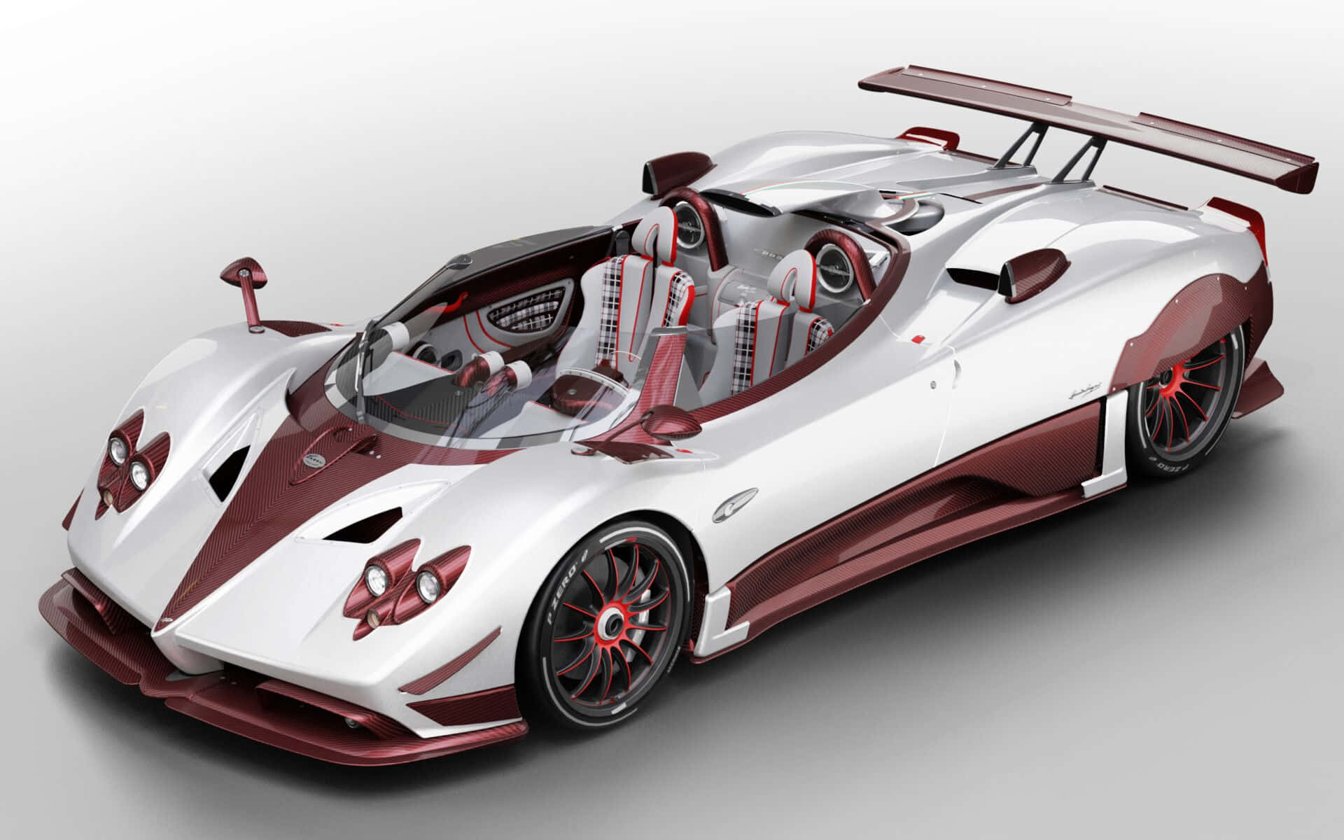 Pagani Zonda Hp Barchetta 桌布 壁紙 — 一輛時尚的白色和栗色帕加尼Zonda跑車，帶有大型後尾翼和裸露的碳纖維細節。