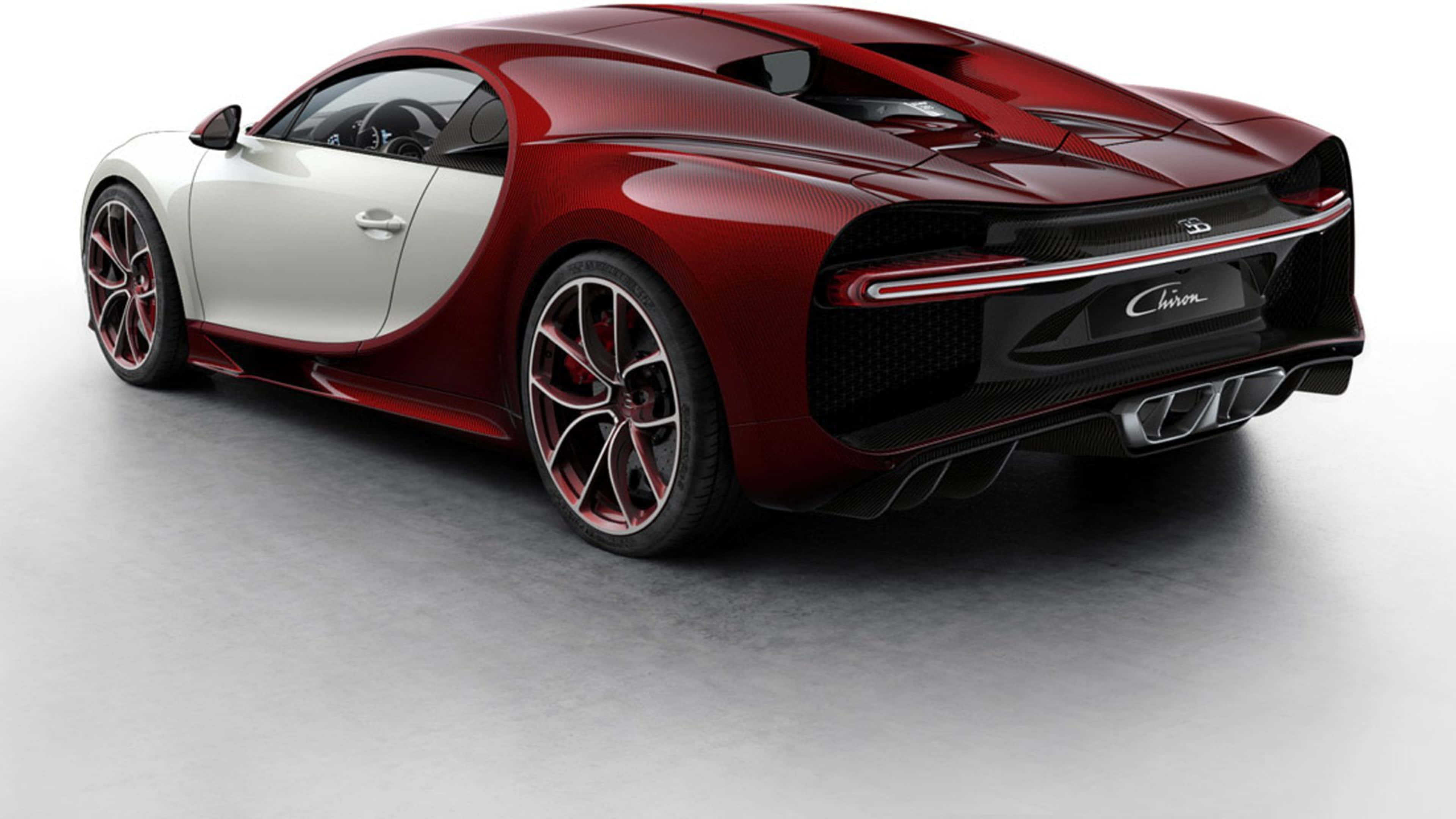 桌布 壁紙 — 一輛時尚的紅白 Bugatti Chiron 跑車，帶有碳纖維細節和發光尾燈，位於簡約的工作室地板上。