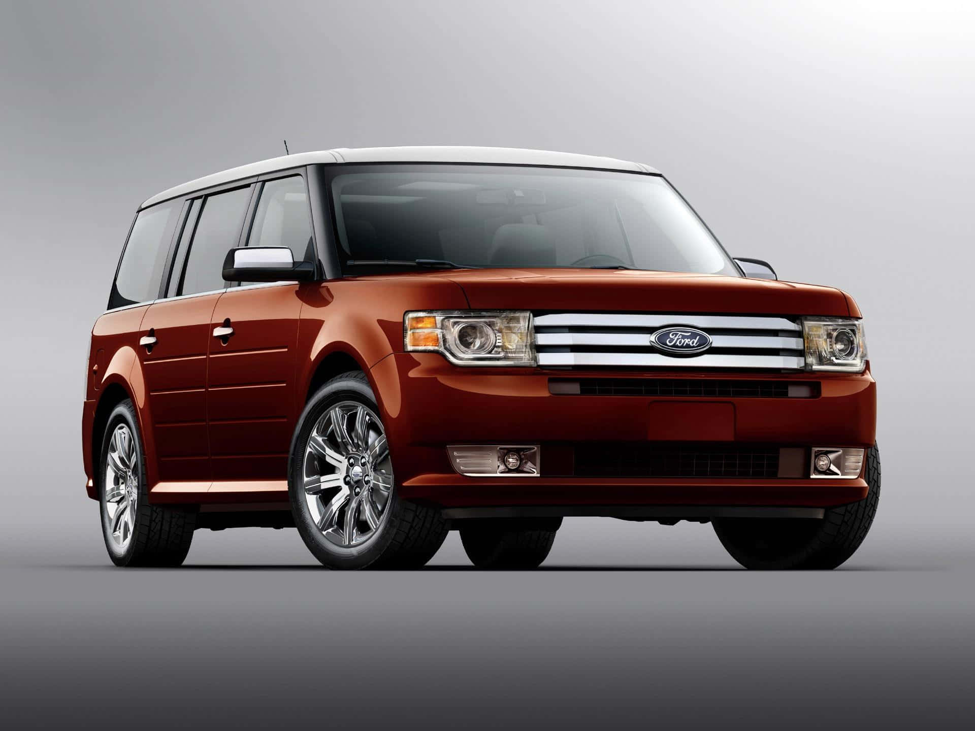 Ford Flex 桌布 壁紙 — 一輛時尚的紅色福特Flex SUV，帶有鍍鉻飾邊和銀色車頂，在極簡灰色工作室背景前蓄勢待發。
