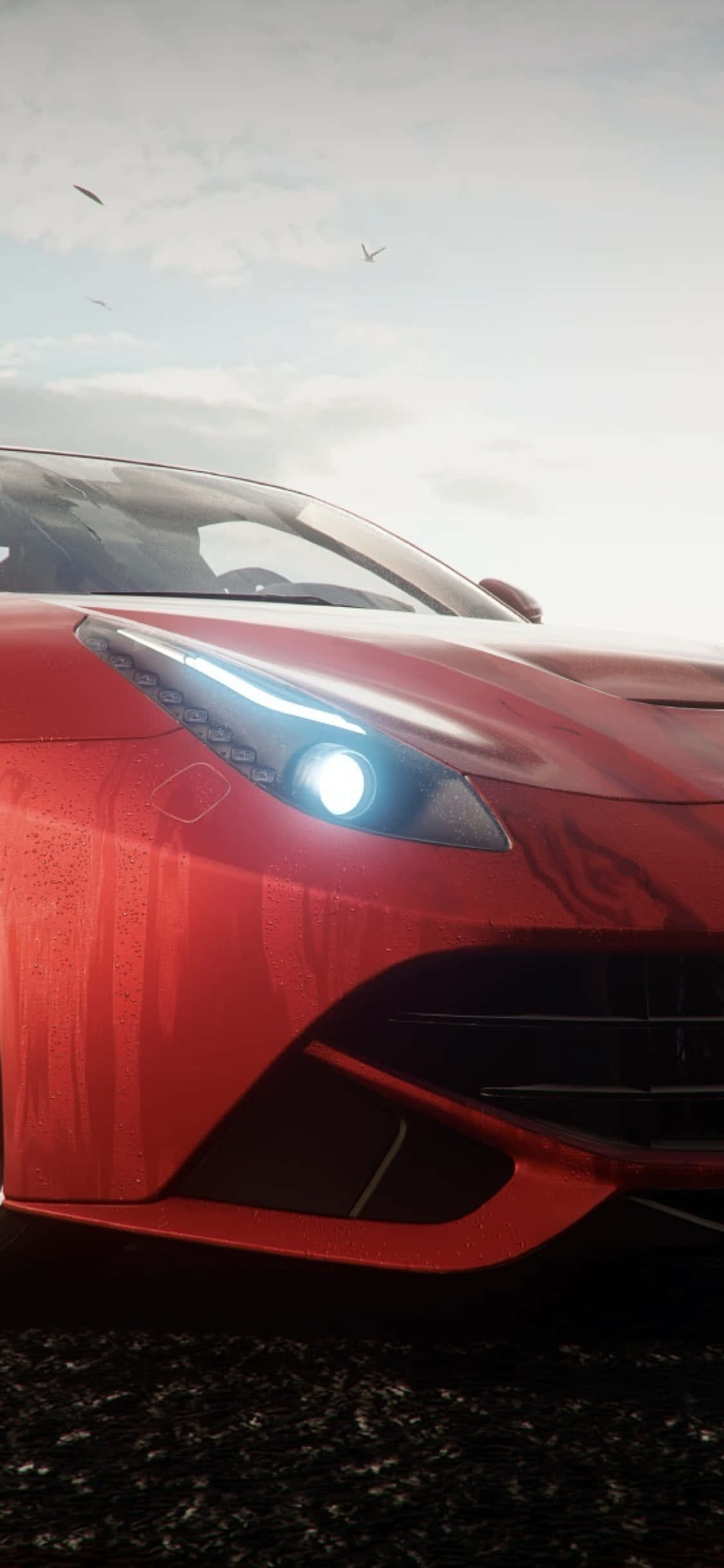 iPhone X Forza Horizon 4 桌布 壁紙 — 一輛時尚的紅色跑車，帶有發光的車頭燈，停在潮濕的道路上，天空多雲，鳥兒飛過。