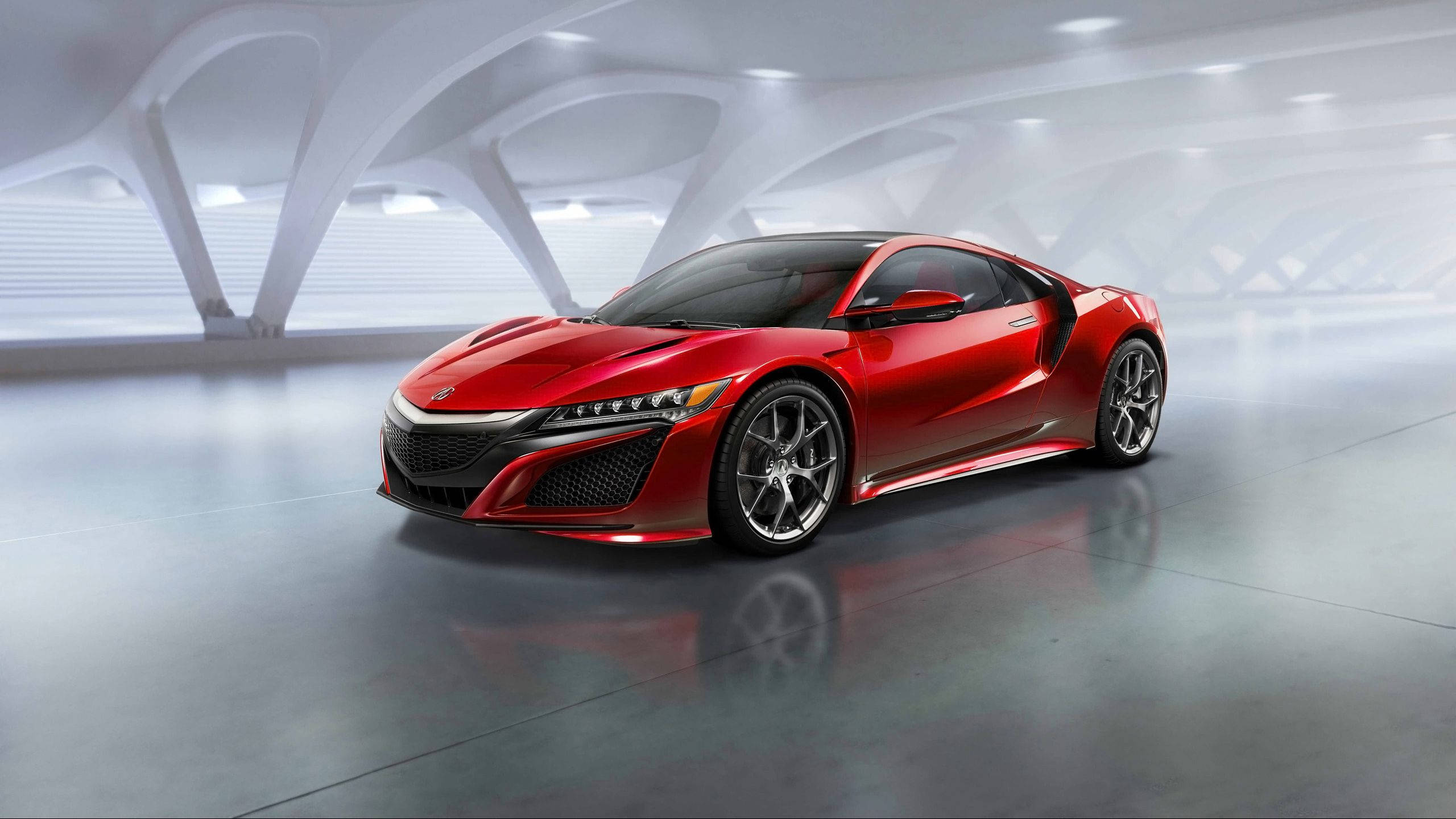 Acura 桌布 壁紙 — 一輛時尚的紅色跑車在明亮的燈光下，在帶有反射地板的未來主義白色拱形車庫中閃閃發光。