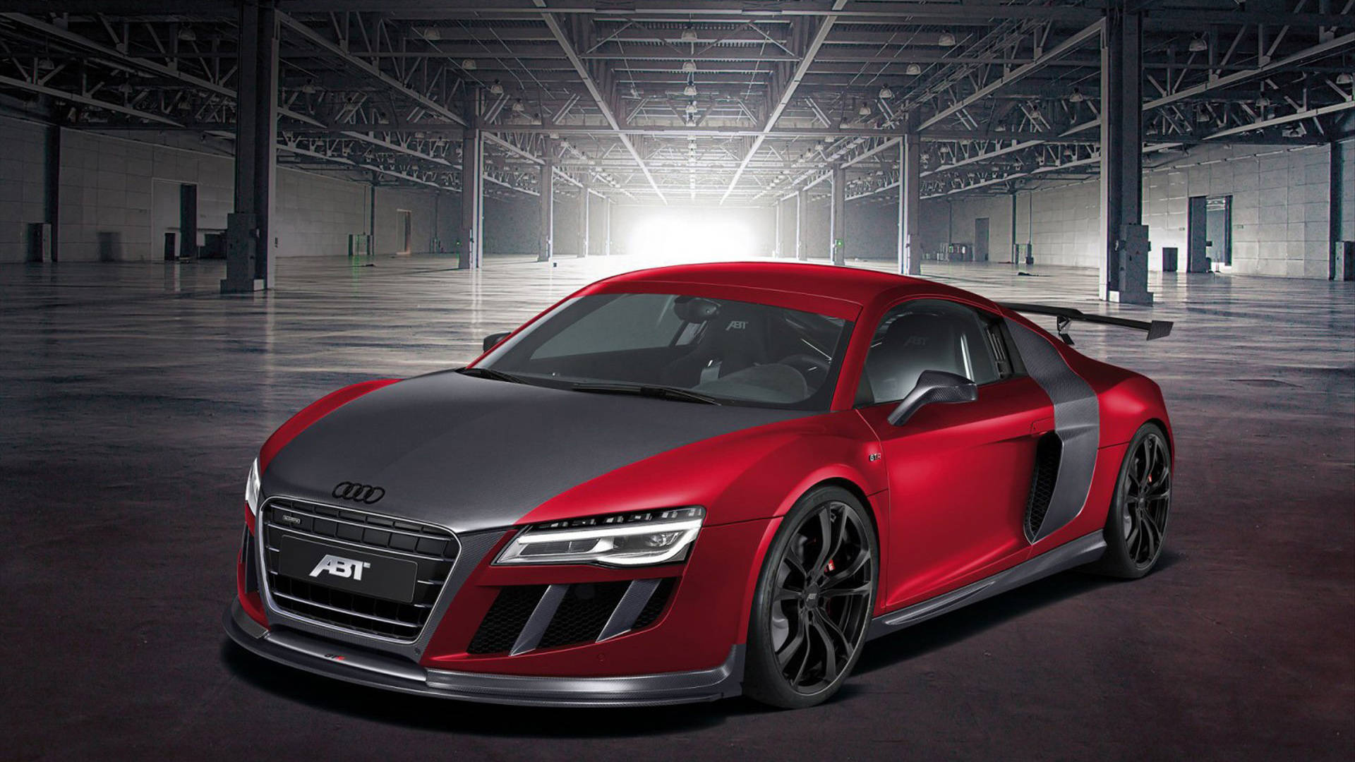 cars 桌布 壁紙 — 一輛時尚的紅黑色ABT Audi R8跑車在廣闊的工業倉庫中，在戲劇性的燈光下閃閃發光。
