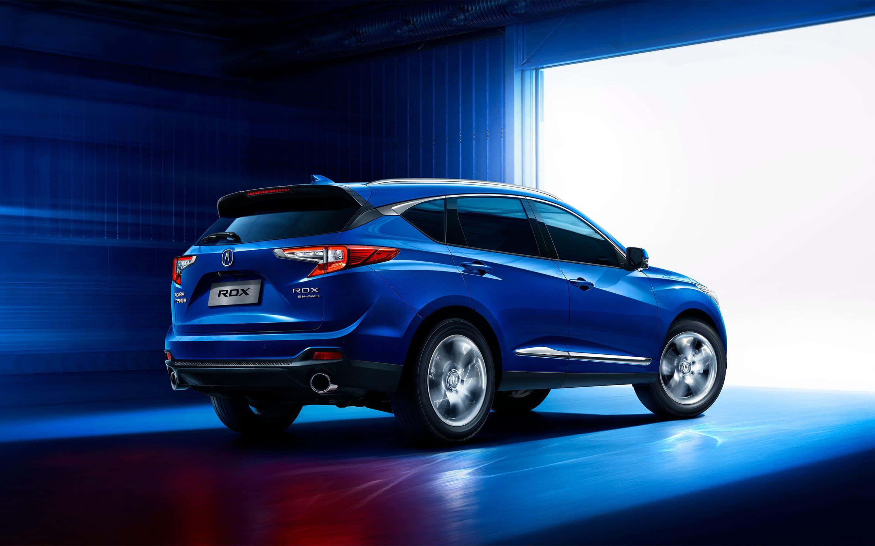 Acura Rdx 桌布 壁紙 — 一輛時尚的藍色Acura RDX SUV在一個戲劇性的工作室中展示，帶有發光的藍色和紅色燈光點綴。