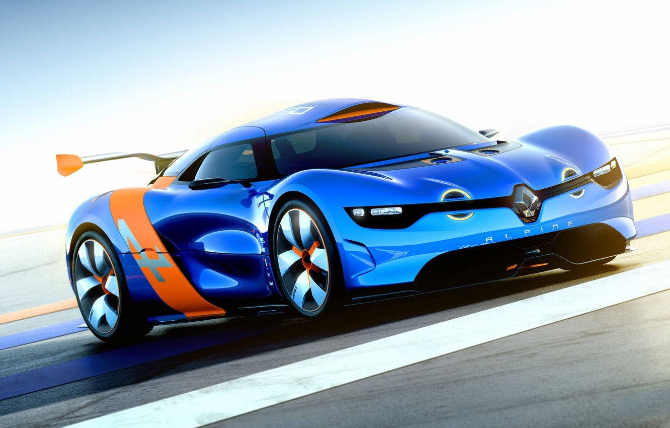 Renault 桌布 壁紙 — 一輛時尚的藍色和橙色Alpine賽車在陽光明媚的賽道上疾馳，帶有動態模糊和銳利的空氣動力學線條。
