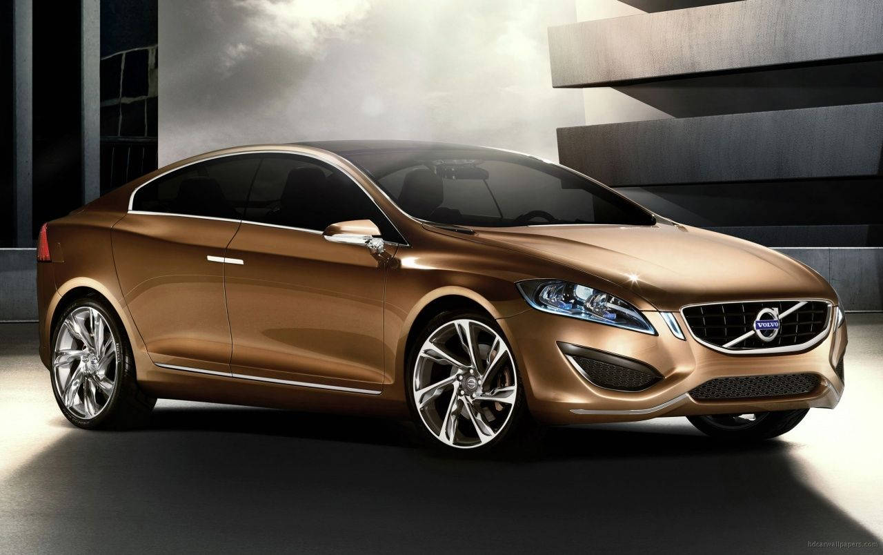 Volvo 桌布 壁紙 — 一輛時尚的金色Volvo概念車在現代混凝土背景下於工作室燈光下閃閃發光。