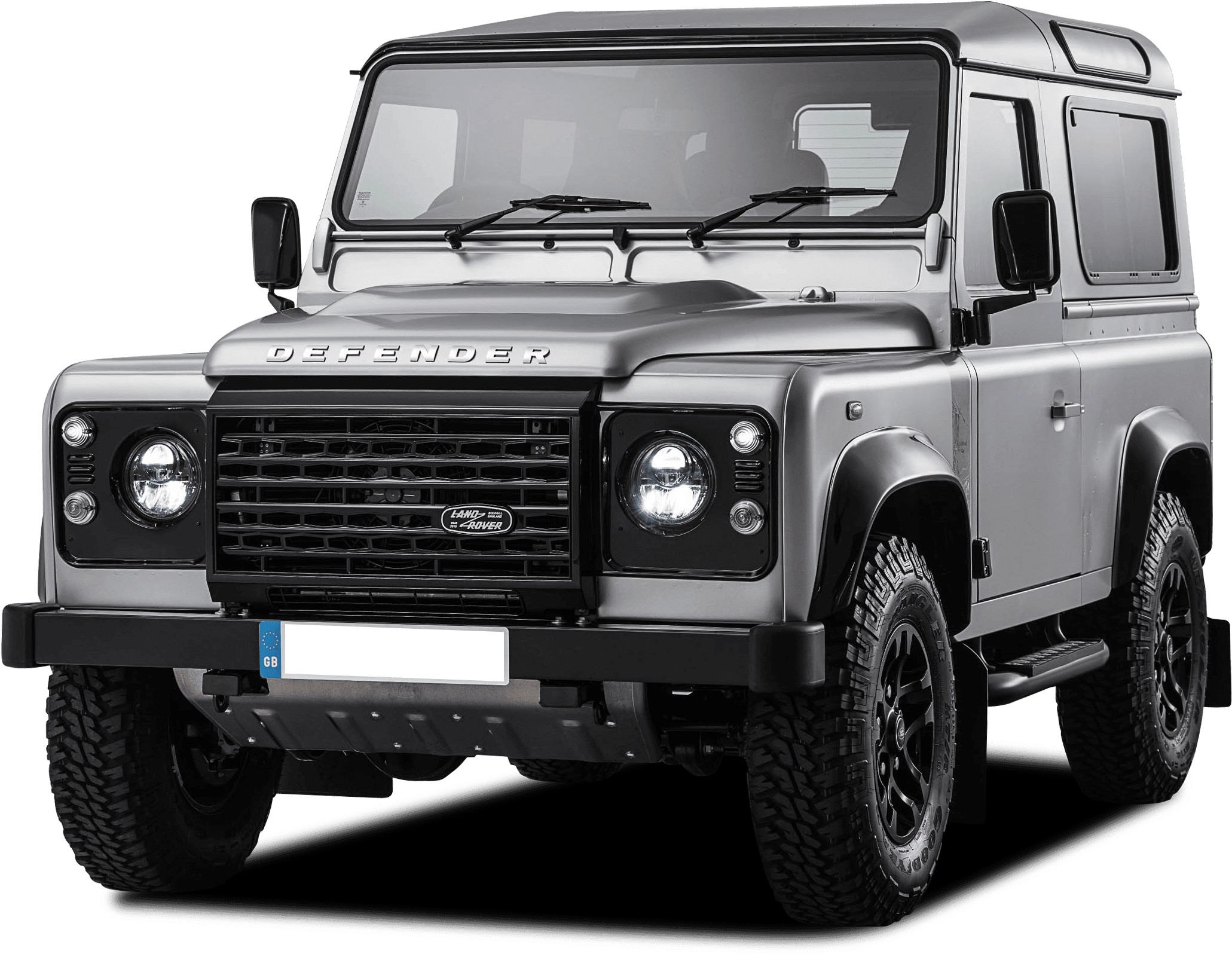 荒原路華 桌布 壁紙 — 一輛時尚的銀色 Land Rover Defender 在黑色背景下展現其堅固的設計和醒目的車頭燈。