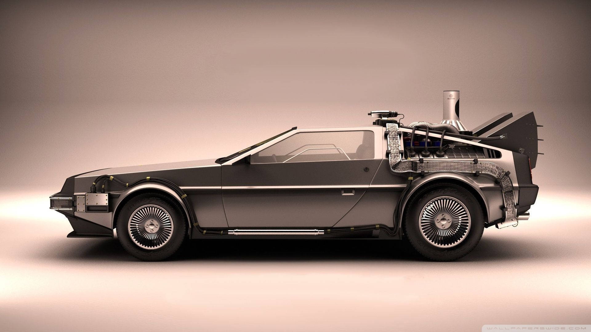 Future 桌布 壁紙 — 一輛時尚的銀色DeLorean跑車，帶有外露的電容器和鷗翼門，背景為工作室漸變色。