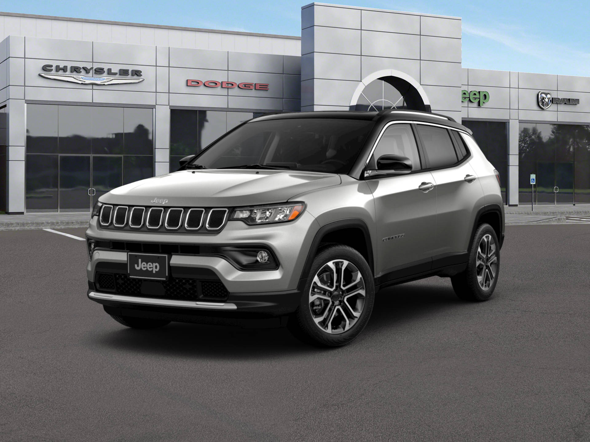Building 桌布 壁紙 — 一輛時尚的銀色Jeep Compass SUV停放在現代化經銷商前，該經銷商帶有Chrysler Dodge Ram品牌標誌，背景是晴朗的藍天。