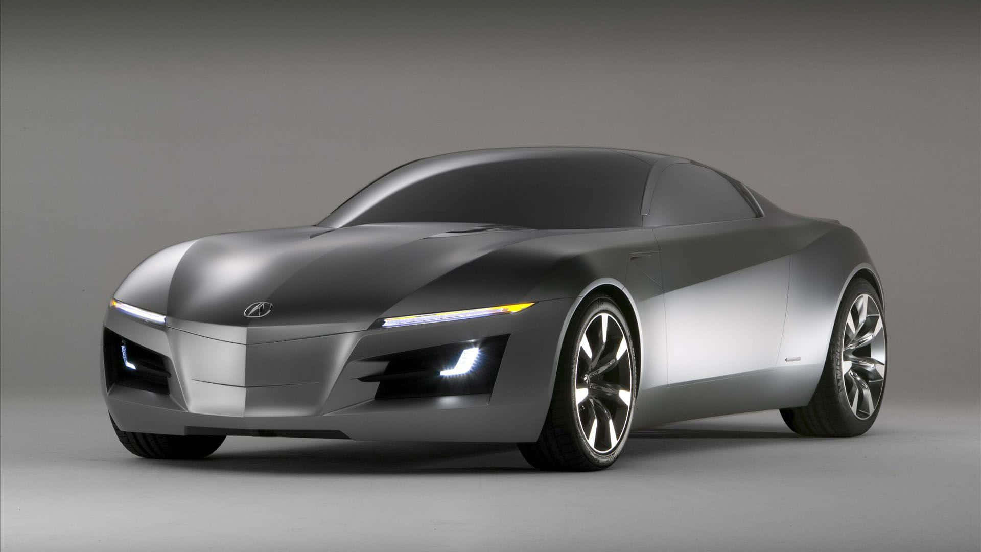 Best Car 桌布 壁紙 — 一輛時尚的銀色未來主義跑車，配備發光頭燈和空氣動力學曲線，以簡約灰色工作室背景為襯托。