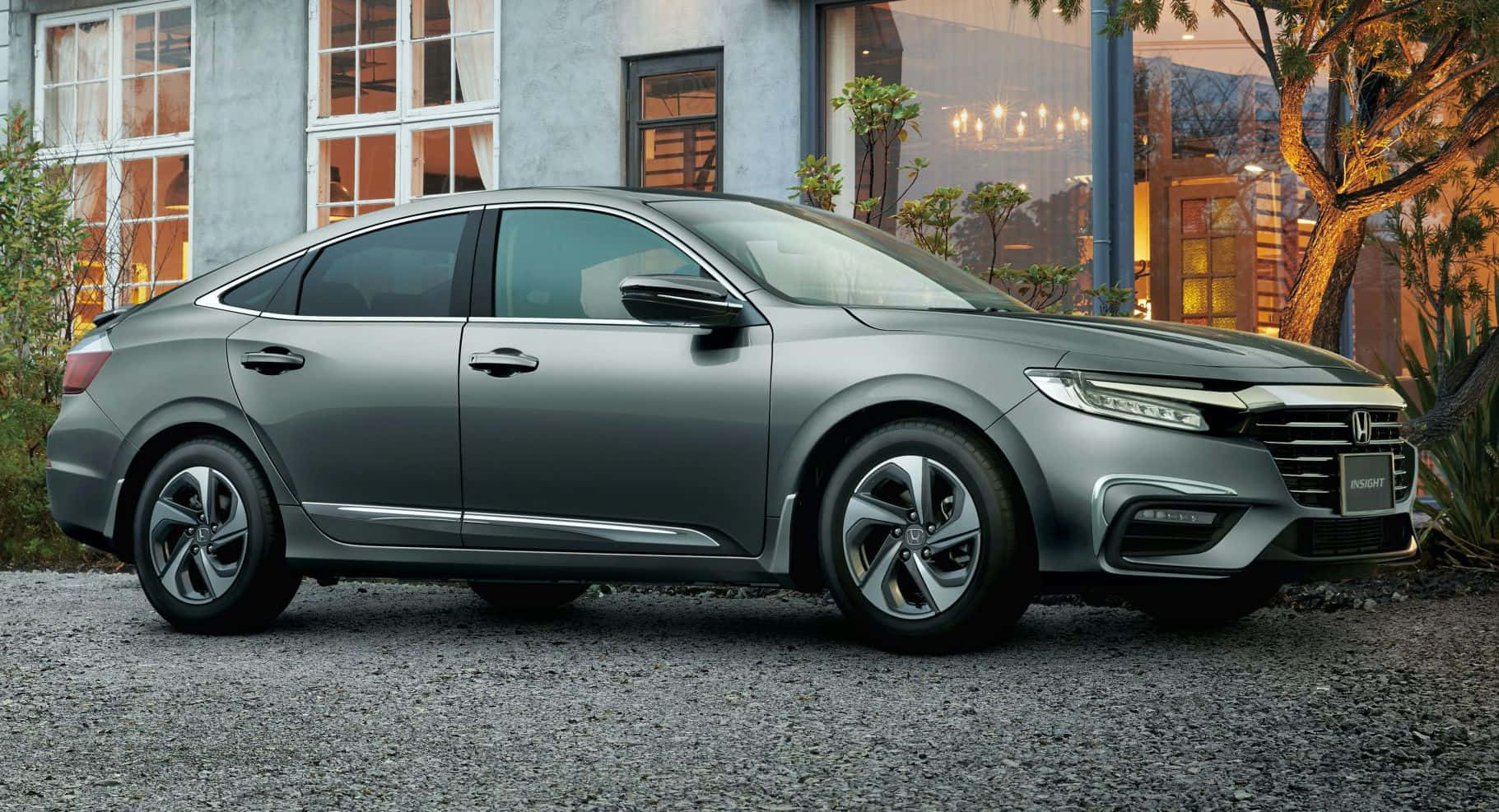 Honda Insight 桌布 壁紙 — 一輛時尚的銀色本田雅閣轎車停放在現代房屋前的碎石路上，正值黃金時刻。