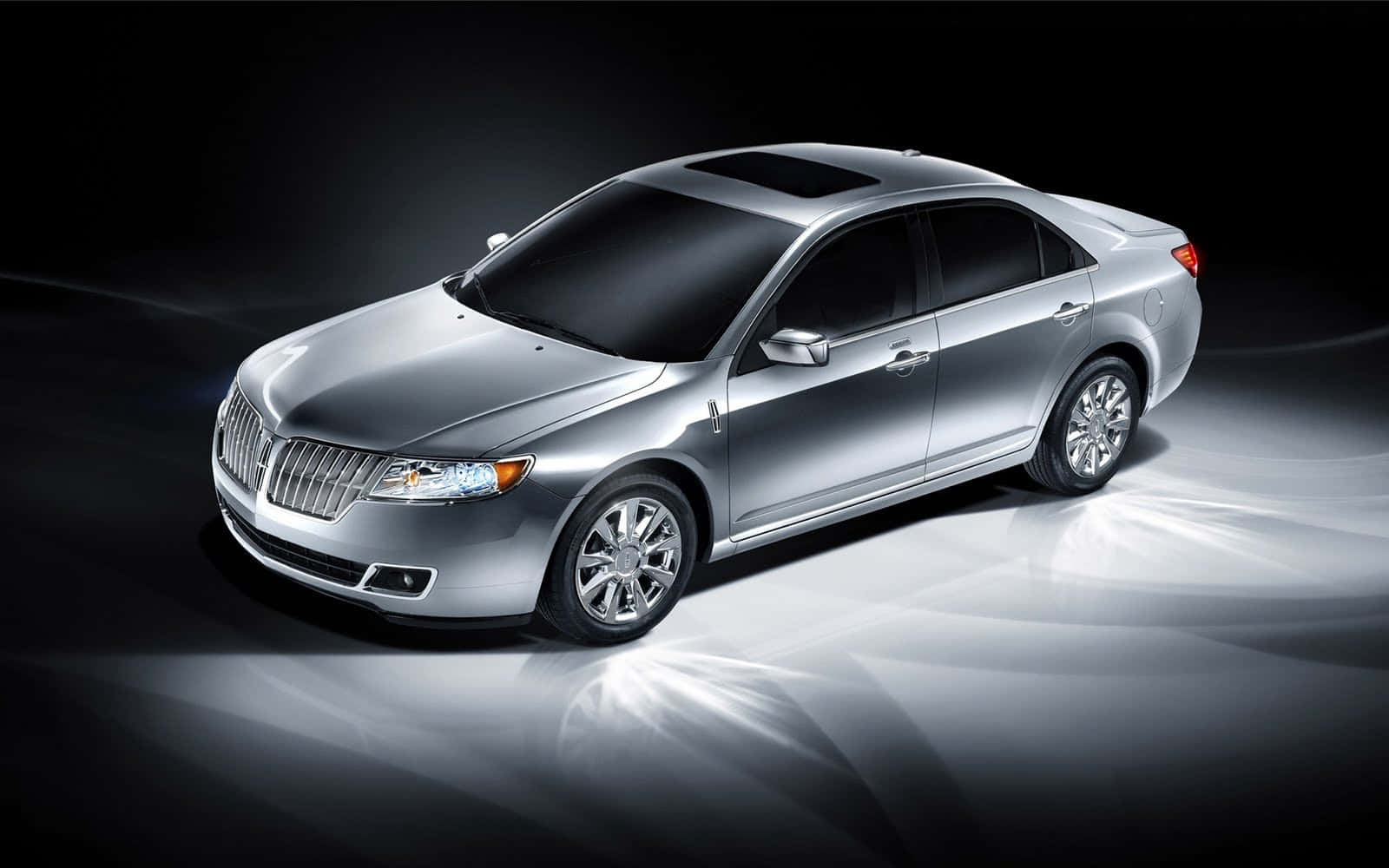 Car Model 桌布 壁紙 — 一輛時尚的銀色林肯轎車在戲劇性的工作室燈光下，在深色背景上閃閃發光。
