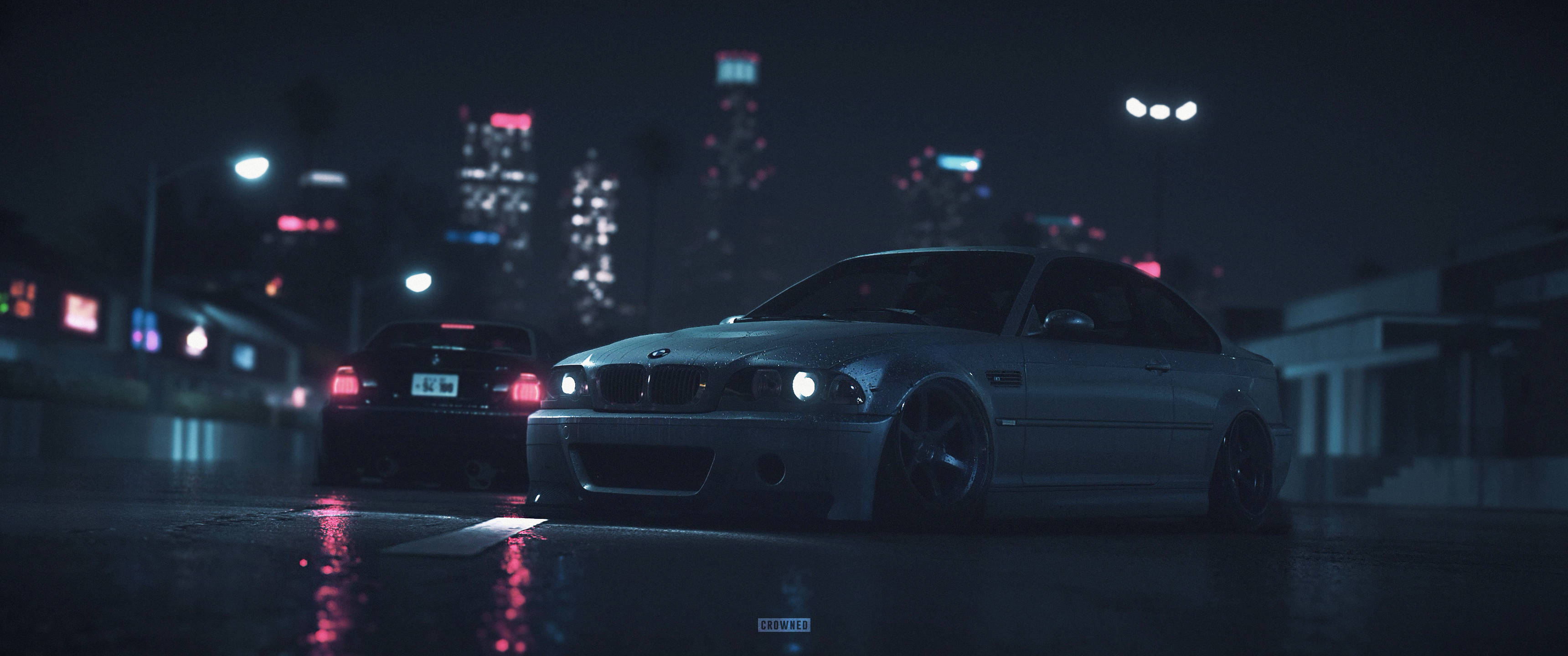Bmw Cars 桌布 壁紙 — 一輛時尚的銀色跑車在夜晚濕漉漉的城市街道上，在霓虹燈下閃耀，背景是模糊的摩天大樓。