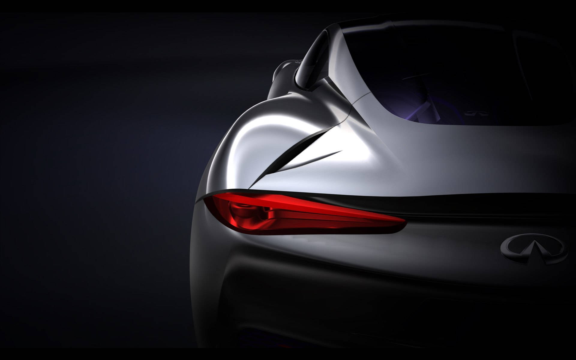 Infiniti 桌布 壁紙 — 一輛時尚的銀色跑車尾部在黑暗的攝影棚背景下發出銳利的紅色尾燈光芒。