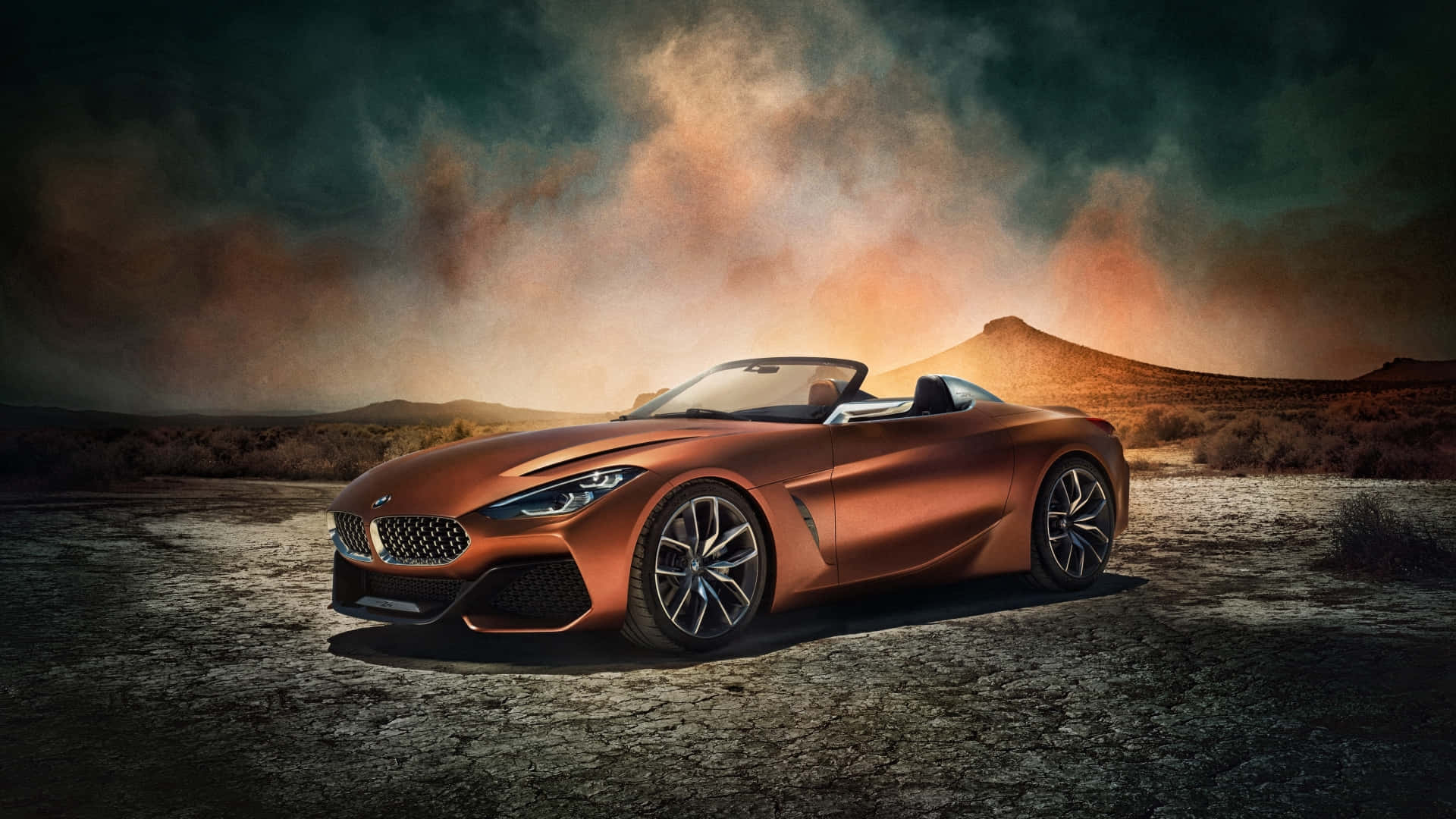 BMW 動圖 桌布 壁紙 — 一輛時尚的銅色BMW敞篷跑車停在龜裂的沙漠地面上，背景是戲劇性的日落天空。