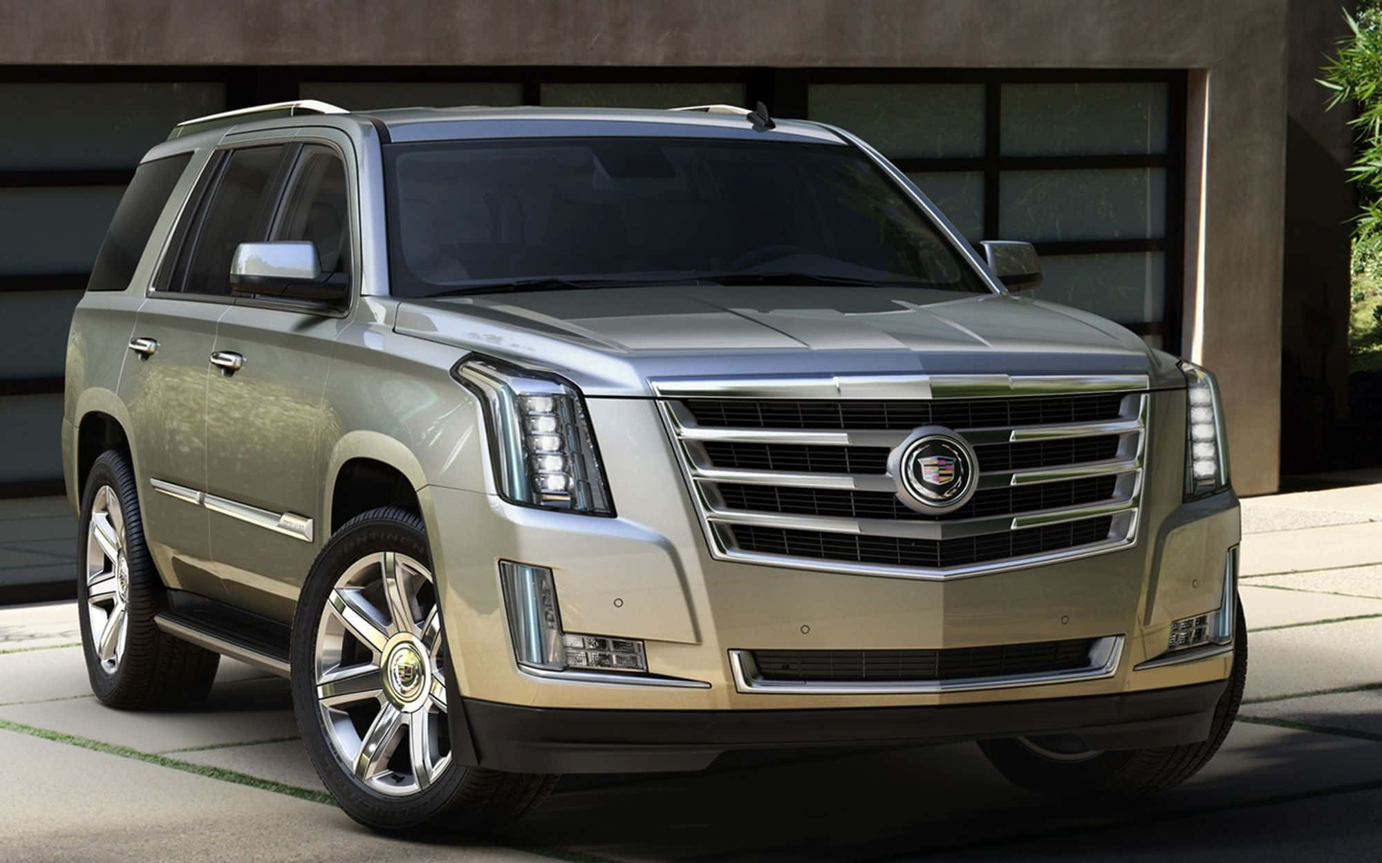 Cadillac Escalade 桌布 壁紙 — 一輛時尚的黃金凱迪拉克SUV停在一棟帶有玻璃門和混凝土牆的現代建築前。