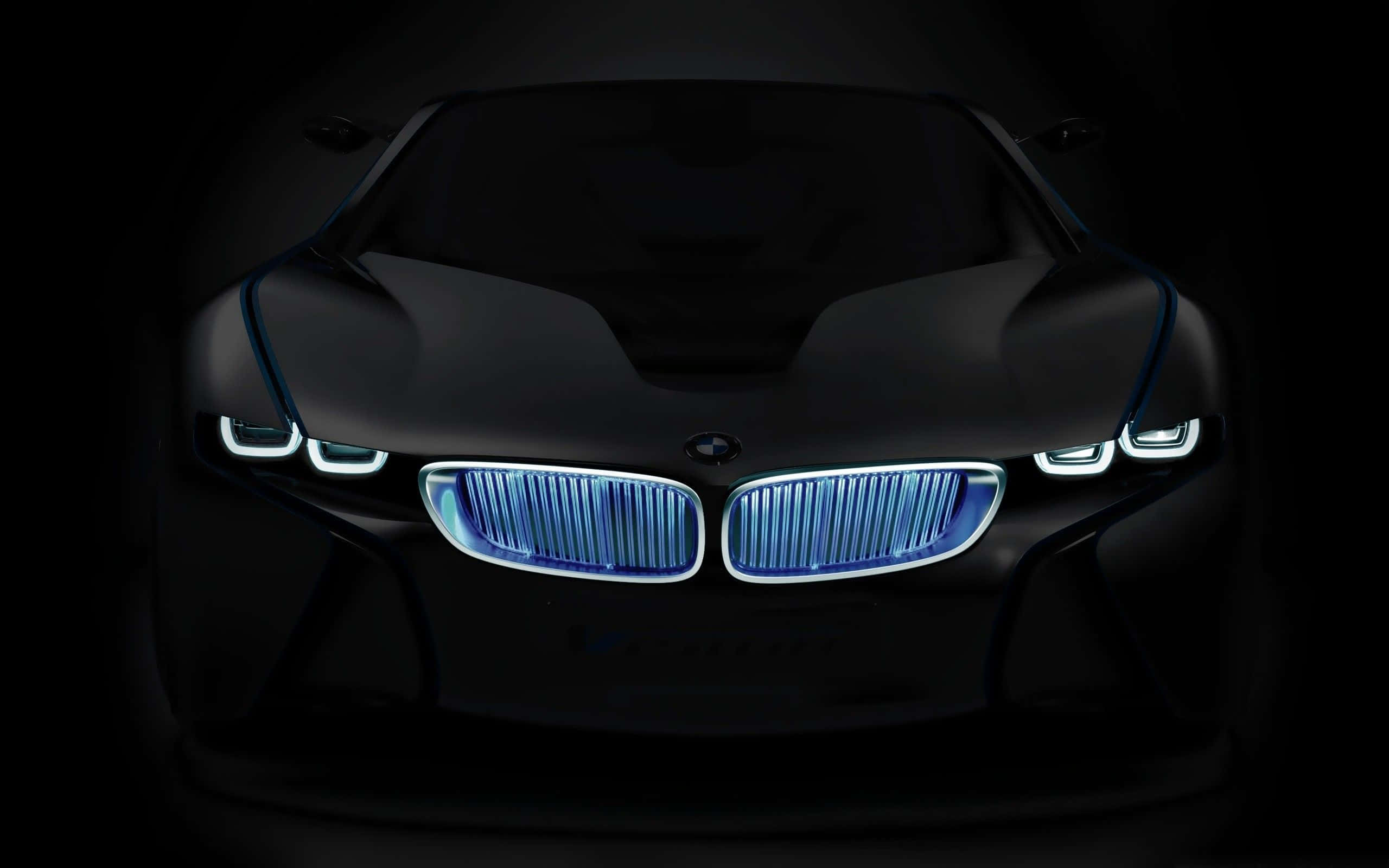Bmw Tablet 桌布 壁紙 — 一輛時尚的黑色BMW概念車，在漆黑背景下散發出鮮豔的藍色頭燈和水箱護罩光芒。