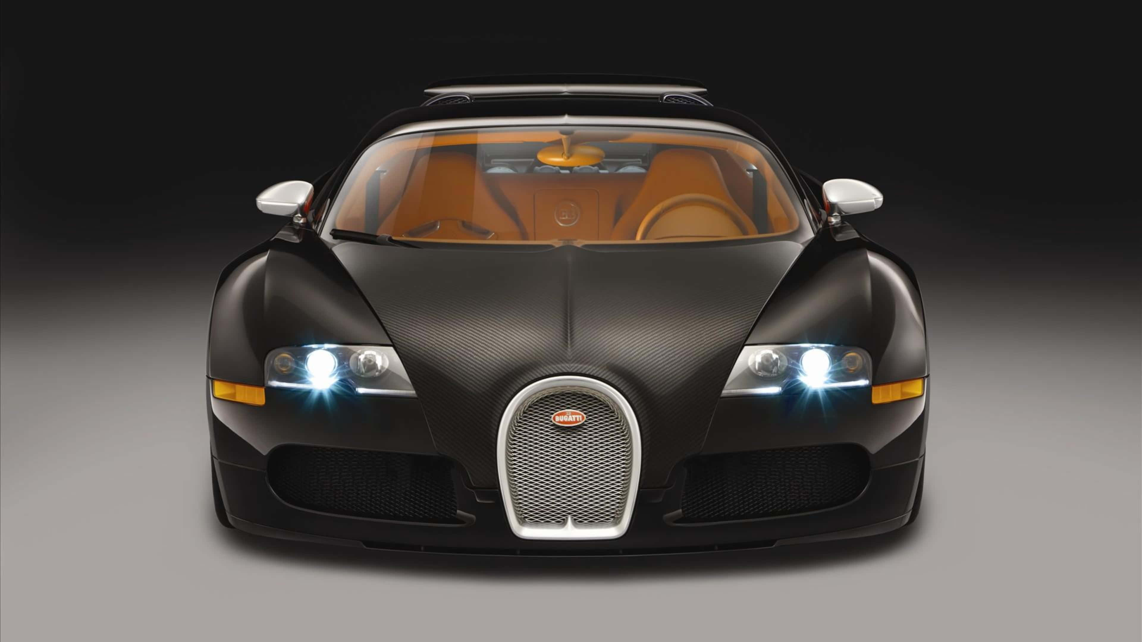 桌布 壁紙 — 一輛時尚的黑色Bugatti Veyron，配備發光頭燈和米色內裝，在深色漸變背景下的工作室拍攝。