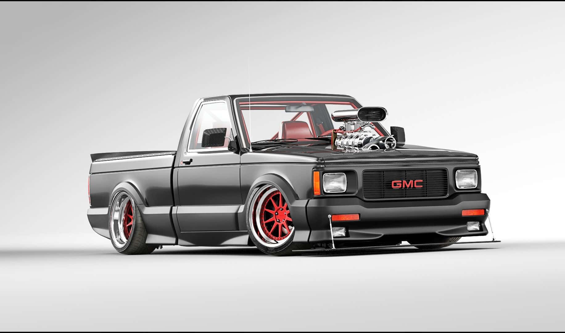 Gmc Syclone 桌布 壁紙 — 一輛時尚的黑色GMC皮卡車，配備紅色輪圈和增壓引擎，在純灰色背景前展示。